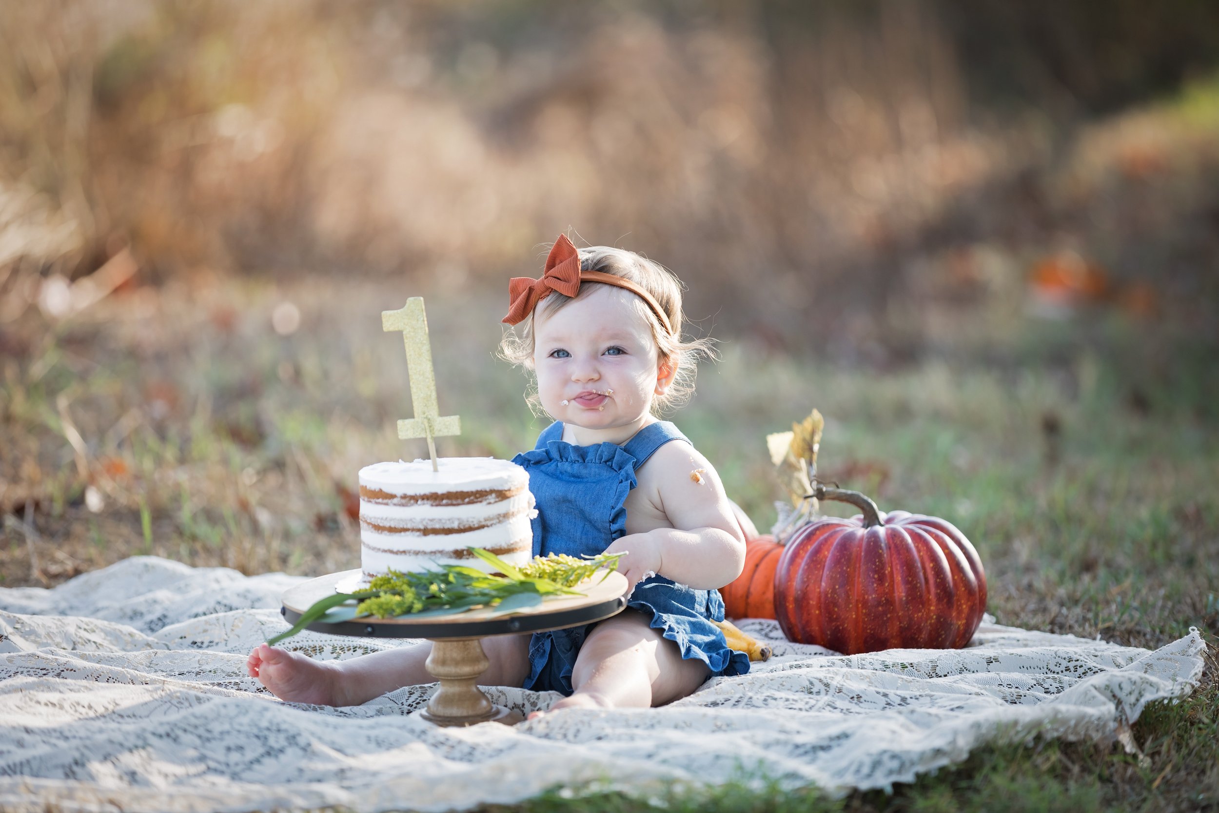 baby-tasting-first-birthday-cake-outdoor-session-austin.jpg