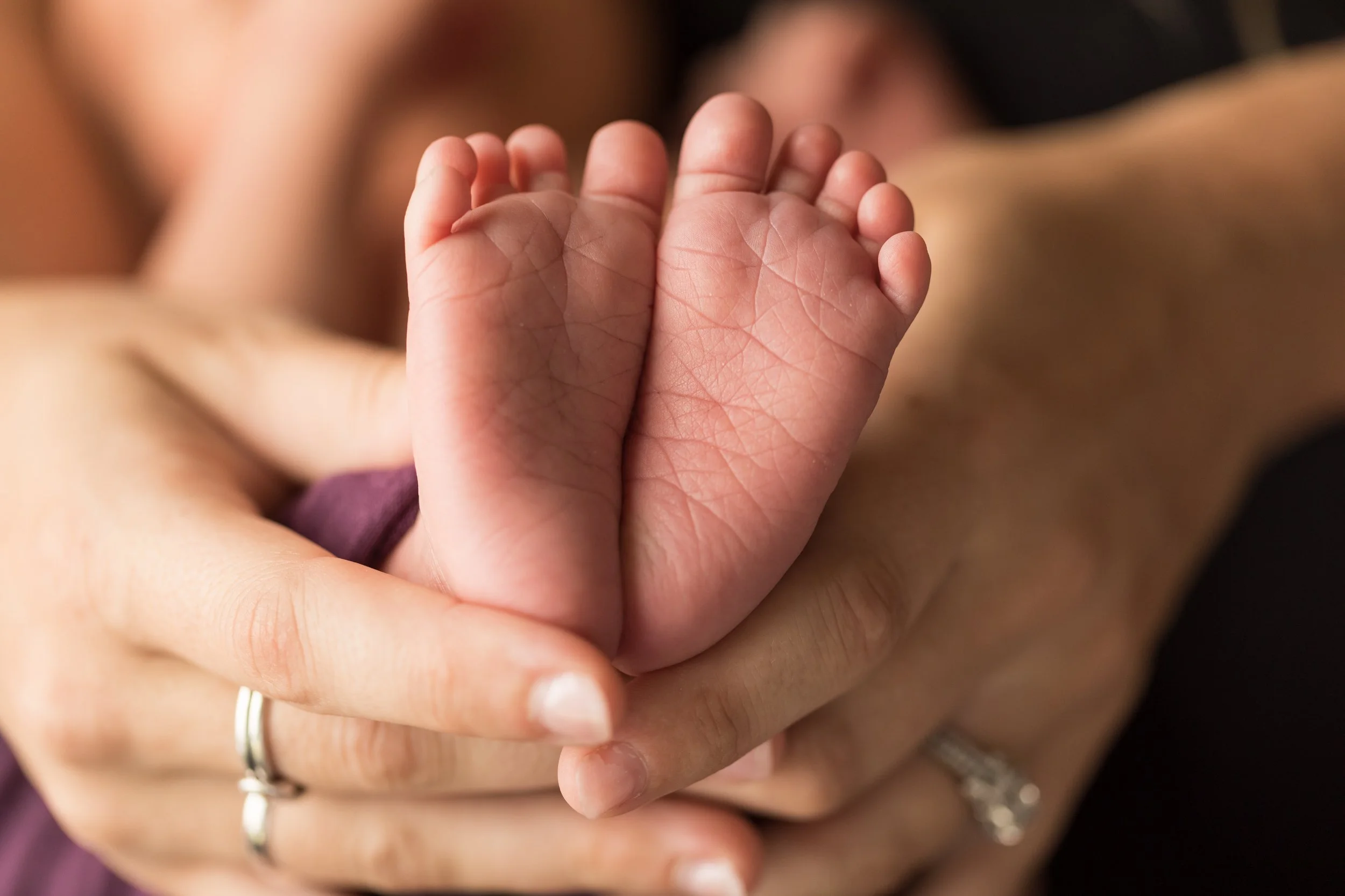 Close-up of newborn baby feet, preserving the tiny details parents never want to forget.