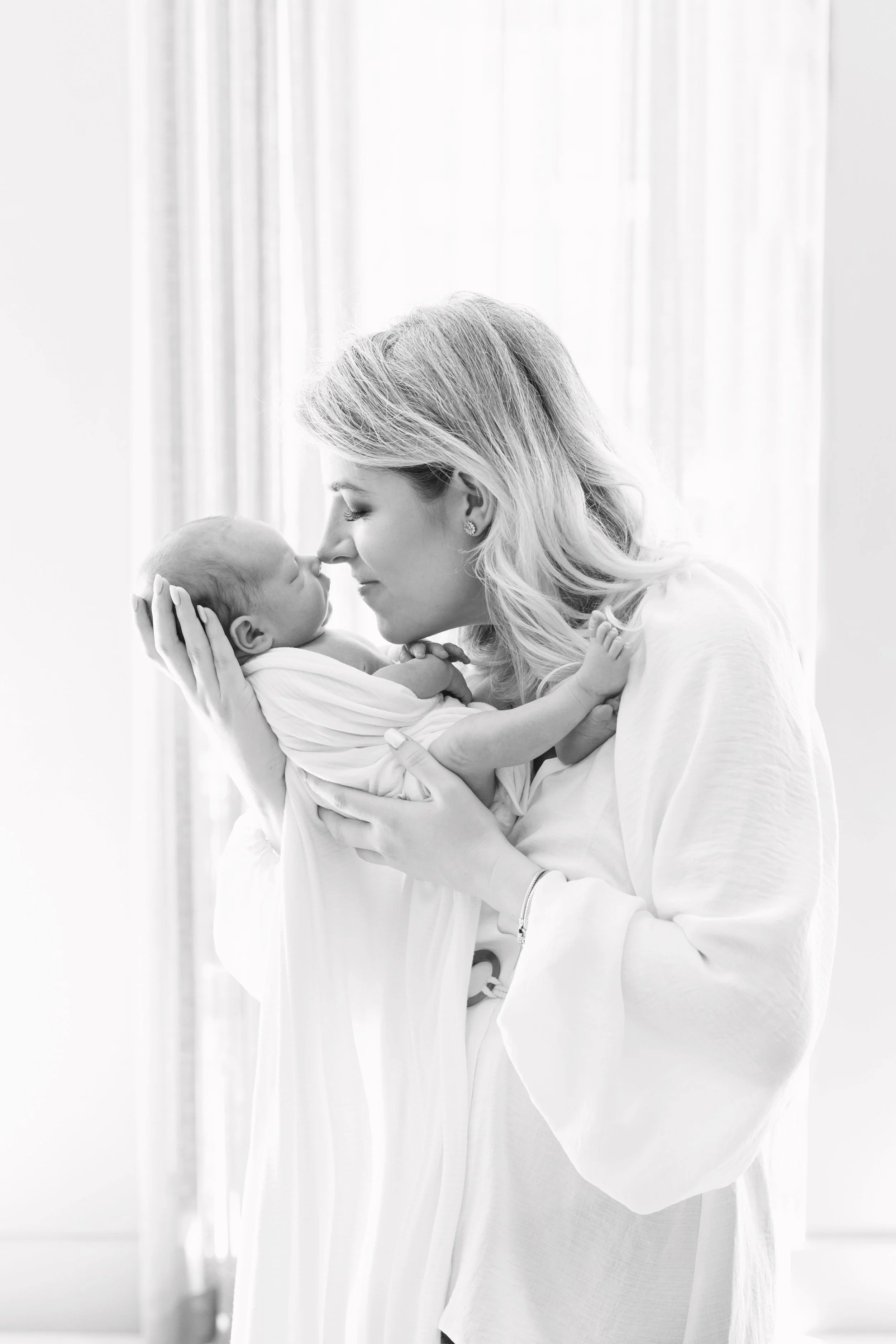 A quiet moment between mother and newborn during an in-home lifestyle newborn session in Austin, Texas.