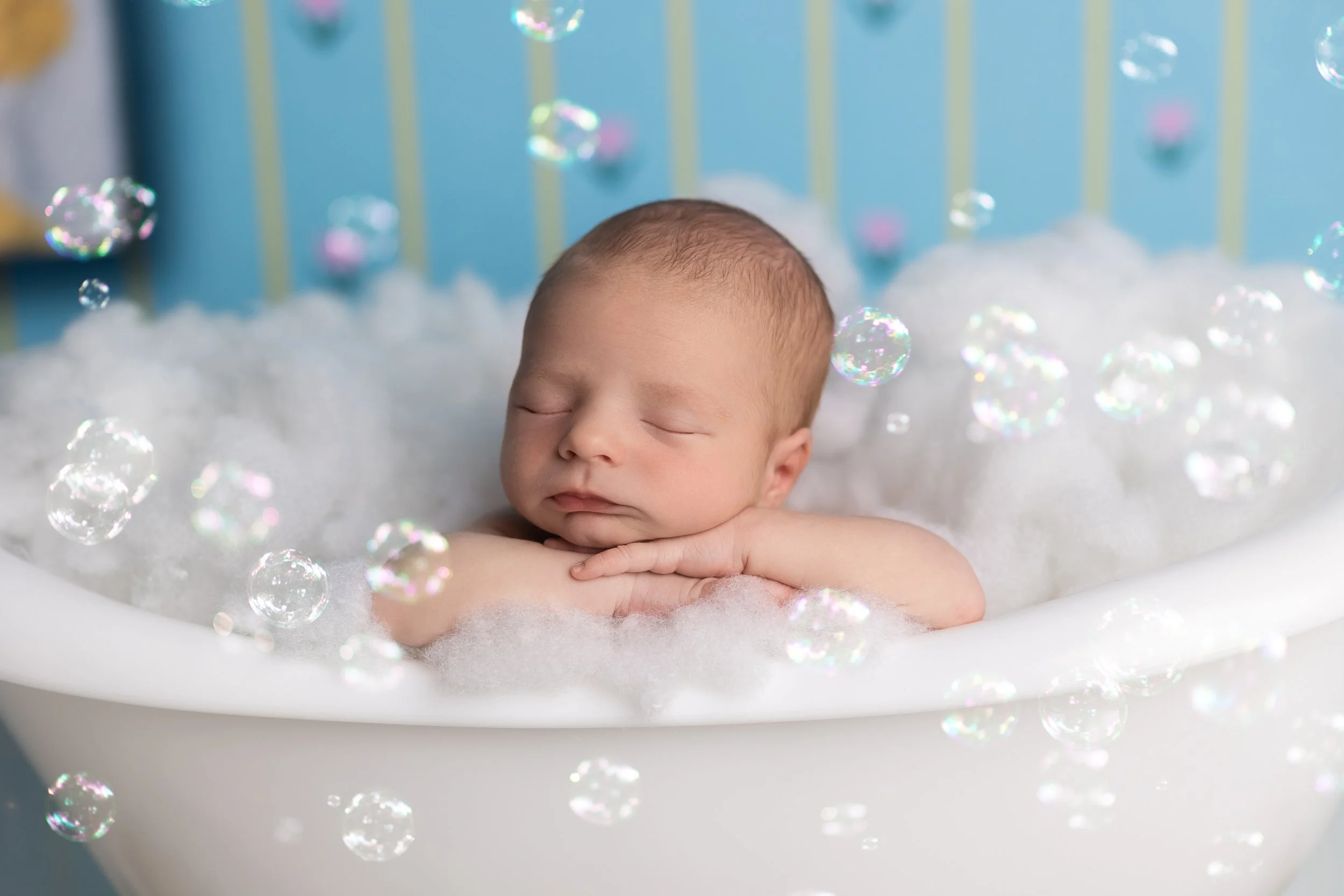 Creative newborn bathtub portrait inspired by baby's home water birth story and personalized family memories.