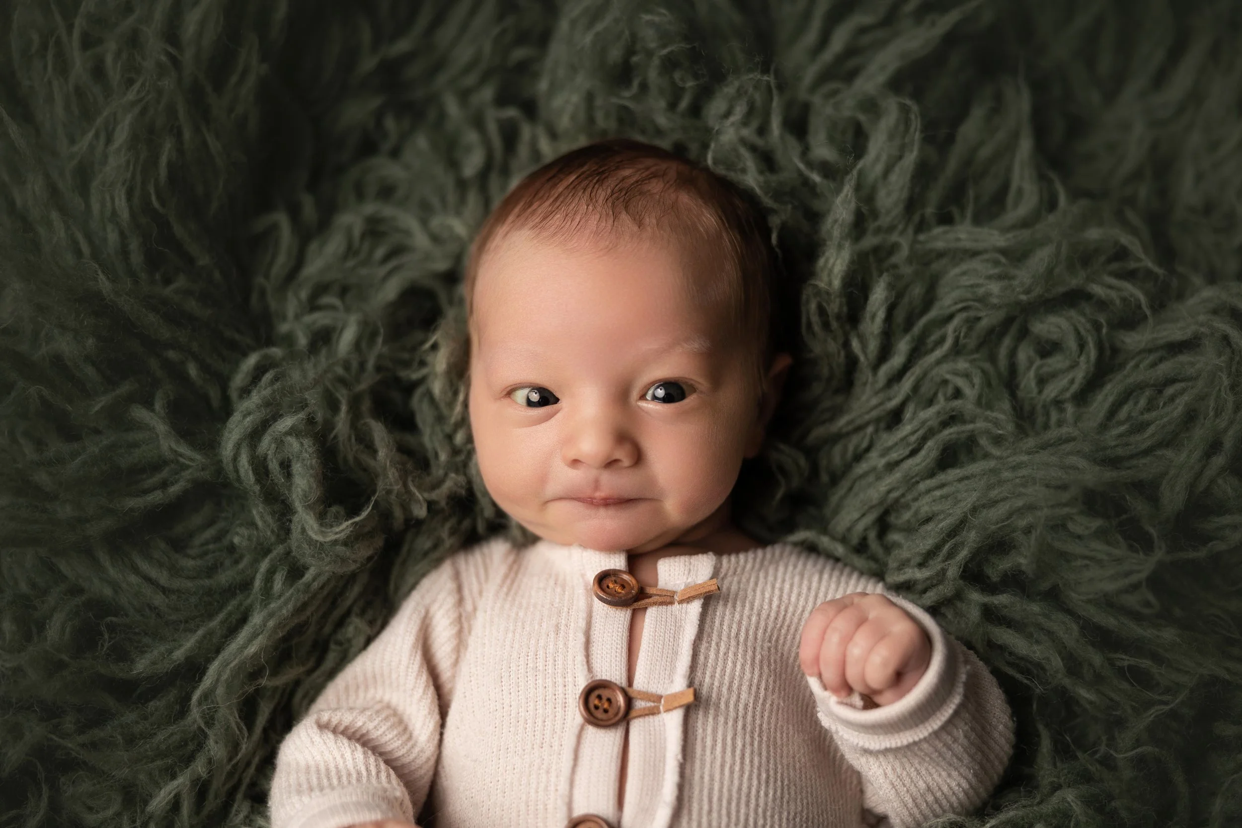 Awake newborn baby making eye contact with the camera during a studio newborn photography session in Austin, Texas.
