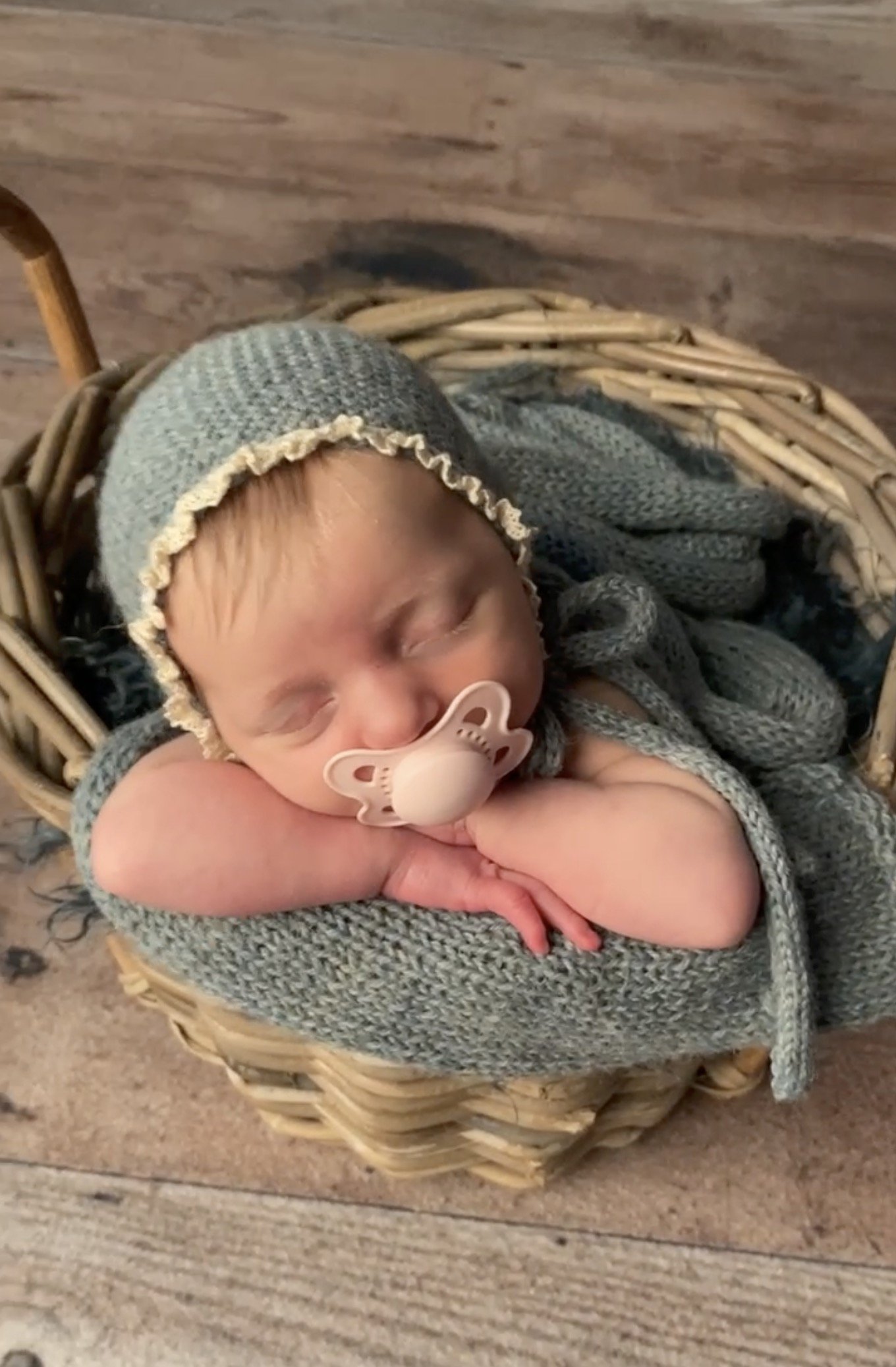 Sleeping newborn baby using pacifier during posed studio newborn photography session in Austin TX