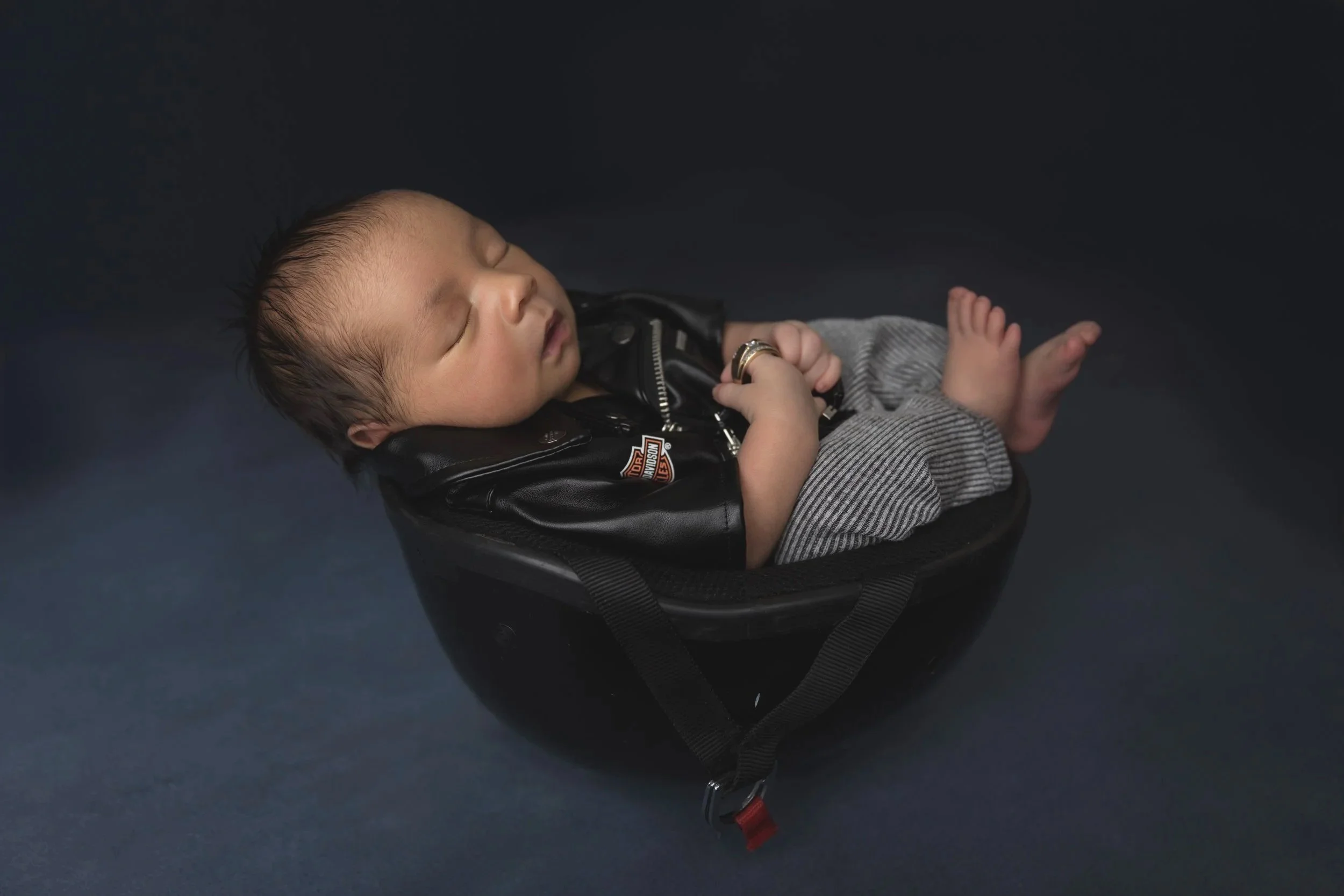 Meaningful newborn portrait honoring a beloved grandfather using family heirlooms and Harley-Davidson memorabilia.