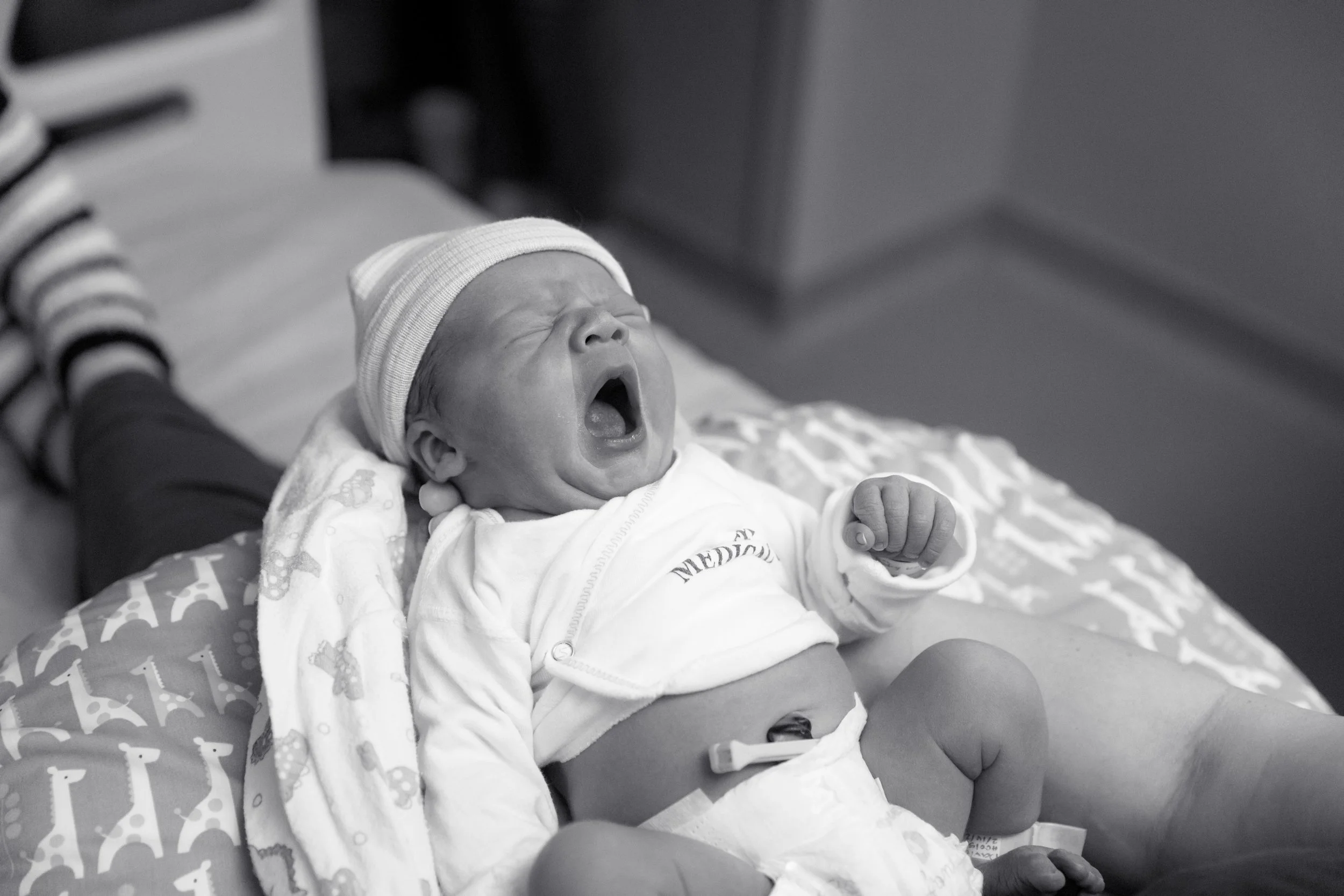Yawning newborn baby photographed during a Fresh 48 hospital photography session in Austin, Texas.
