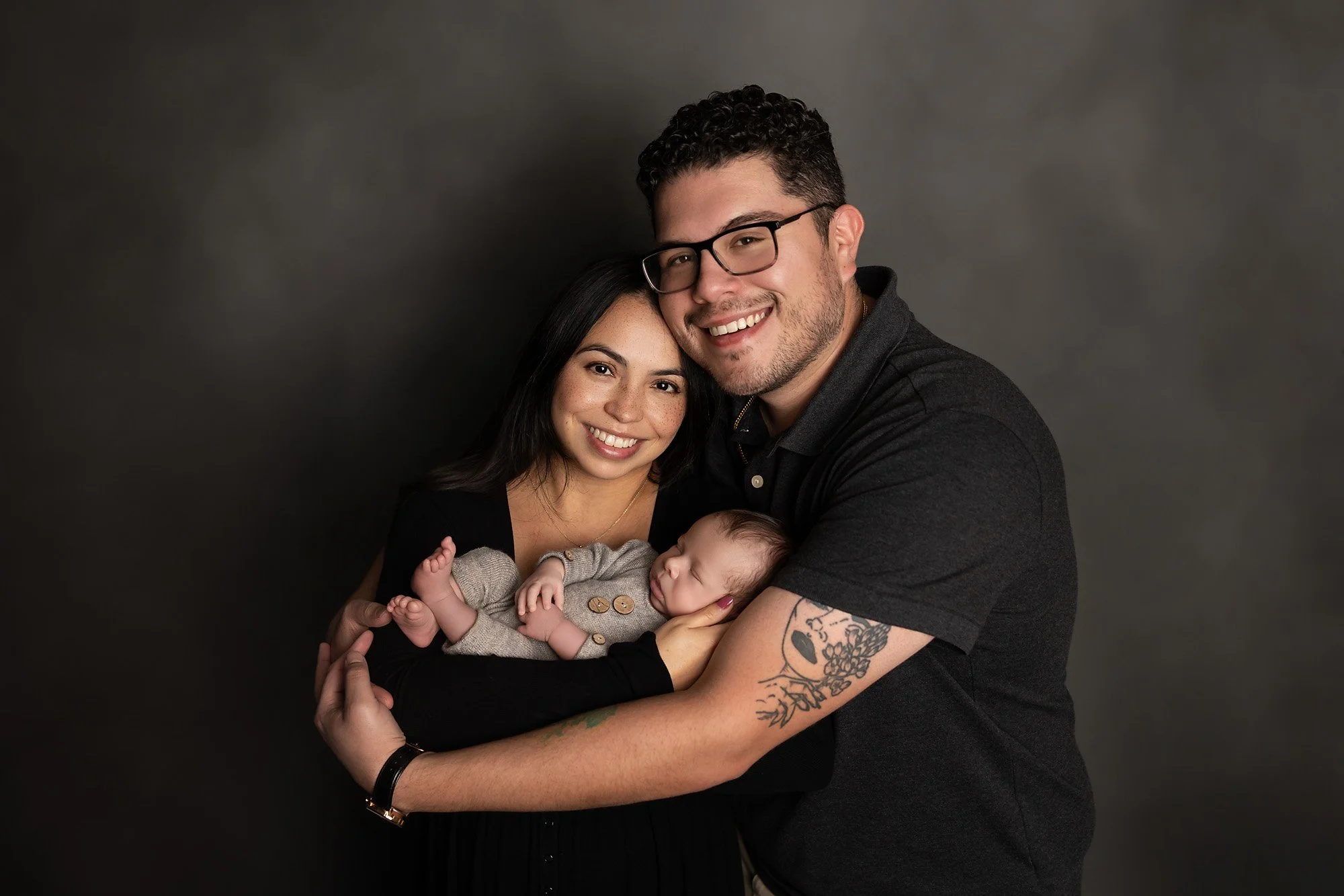 studio portrait of parent and newborn baby boy