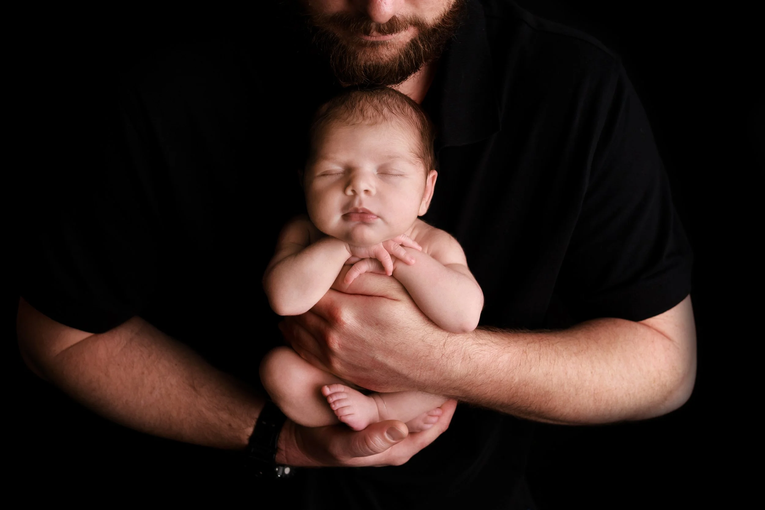 close-up of baby with dad snuggling her