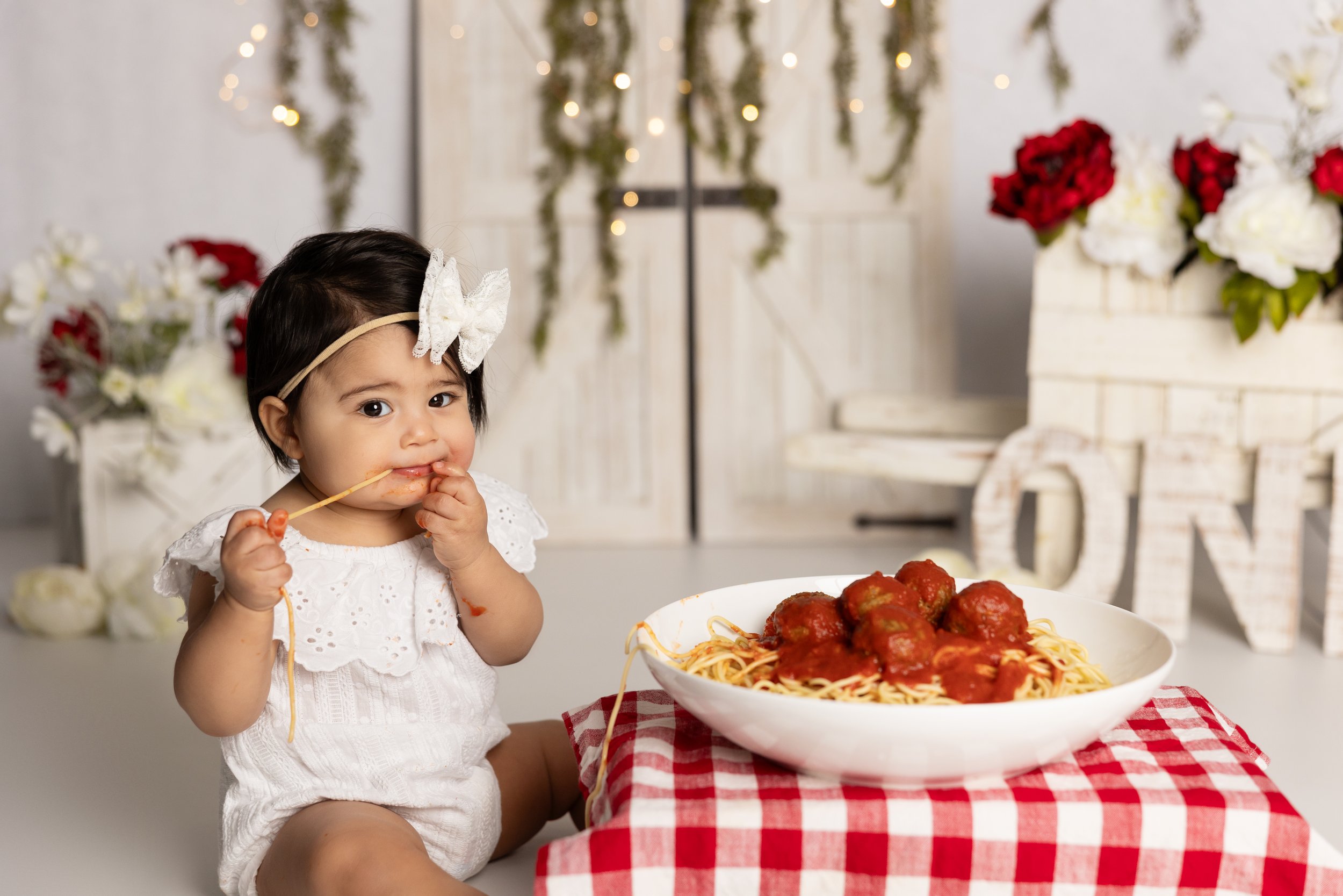 baby girl eating spaghetti in Austin baby photography session