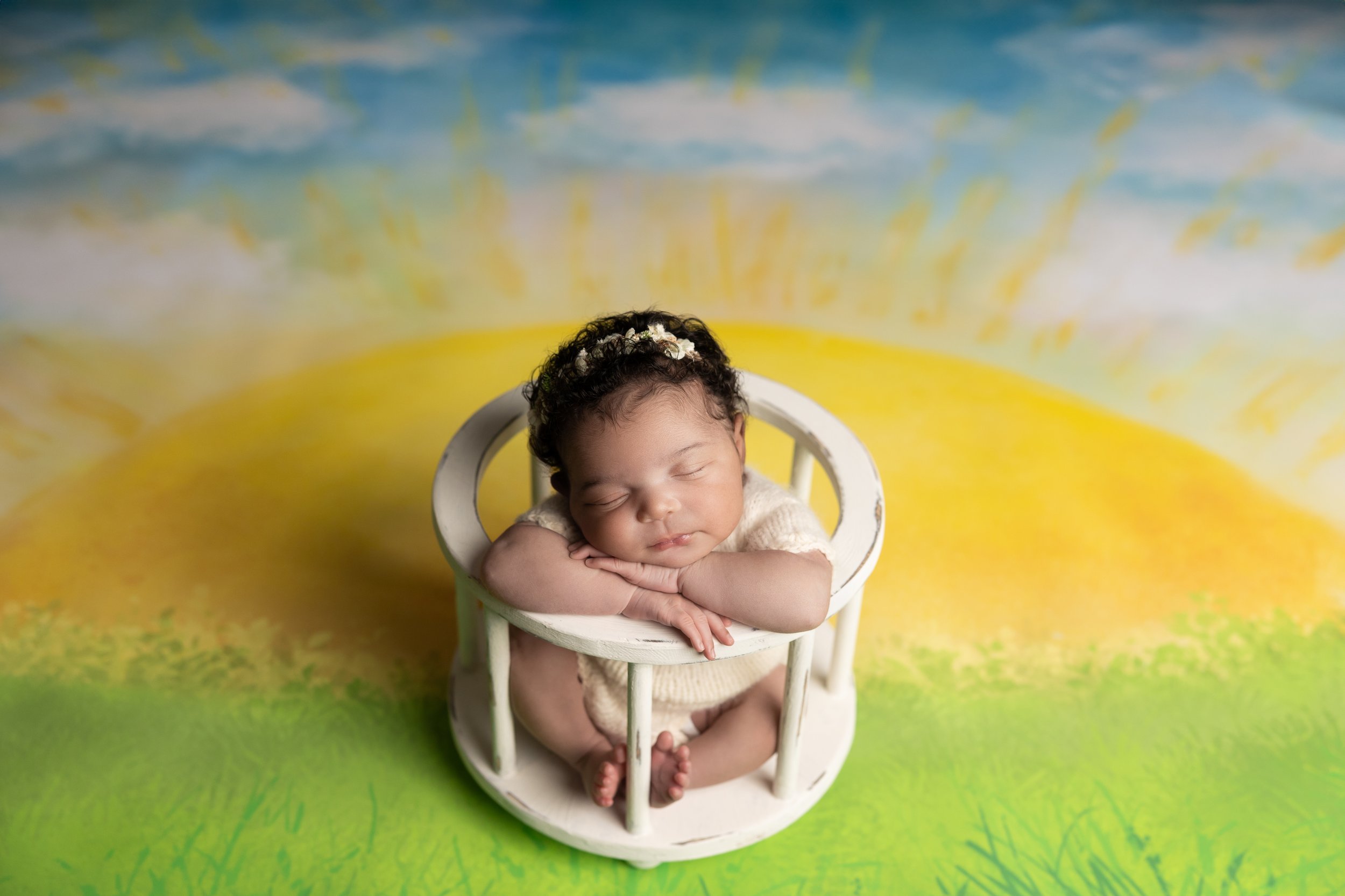 Name-inspired newborn portrait celebrating baby's middle name Soleil with a custom sunshine-themed setup.