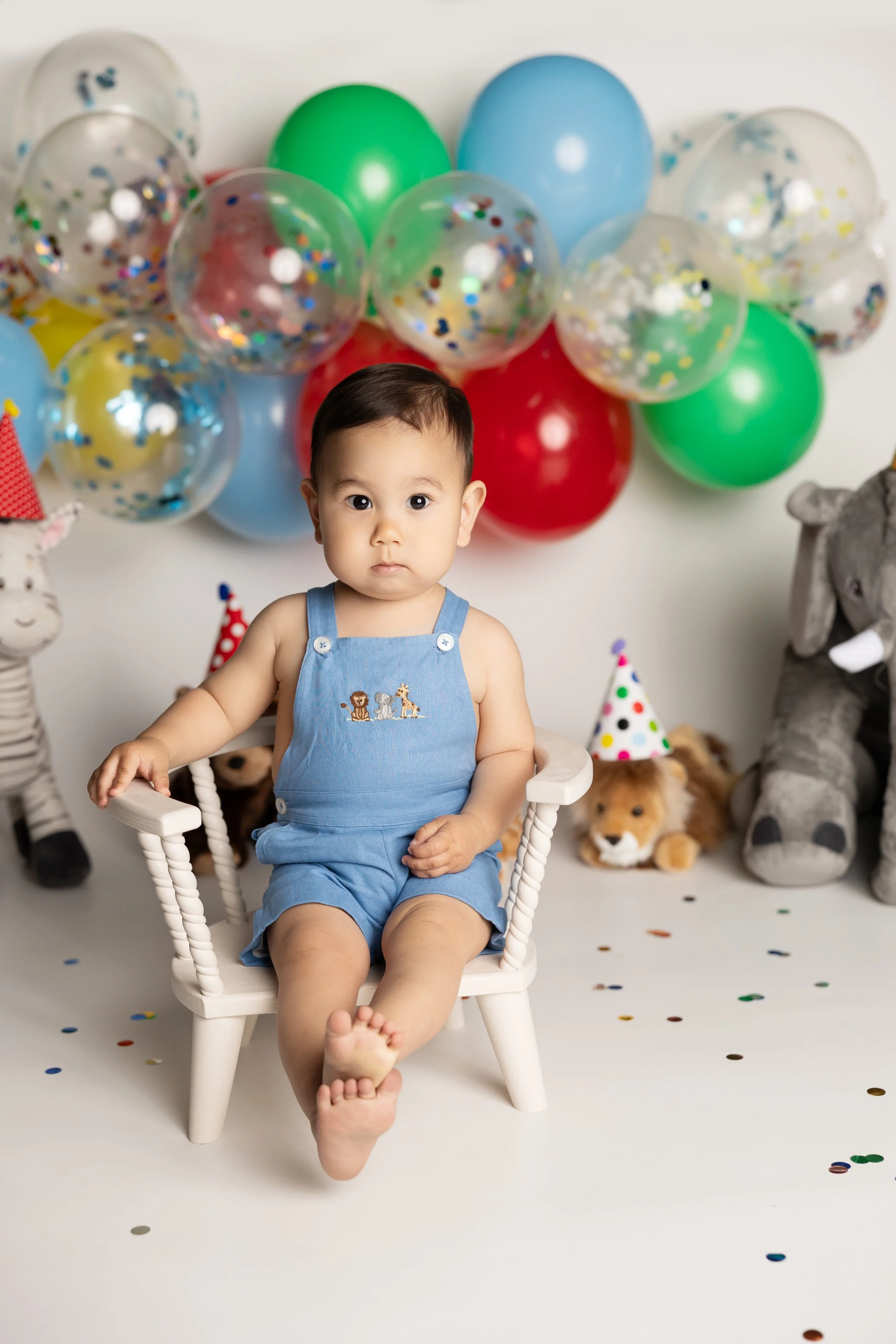 Colorful birthday balloon setup for a one-year milestone photography session.