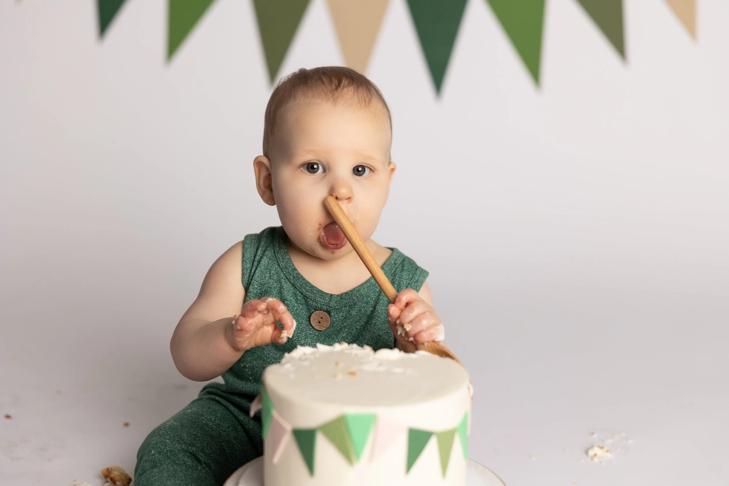 One-year-old baby celebrating a first birthday cake smash photography session in Austin TX.