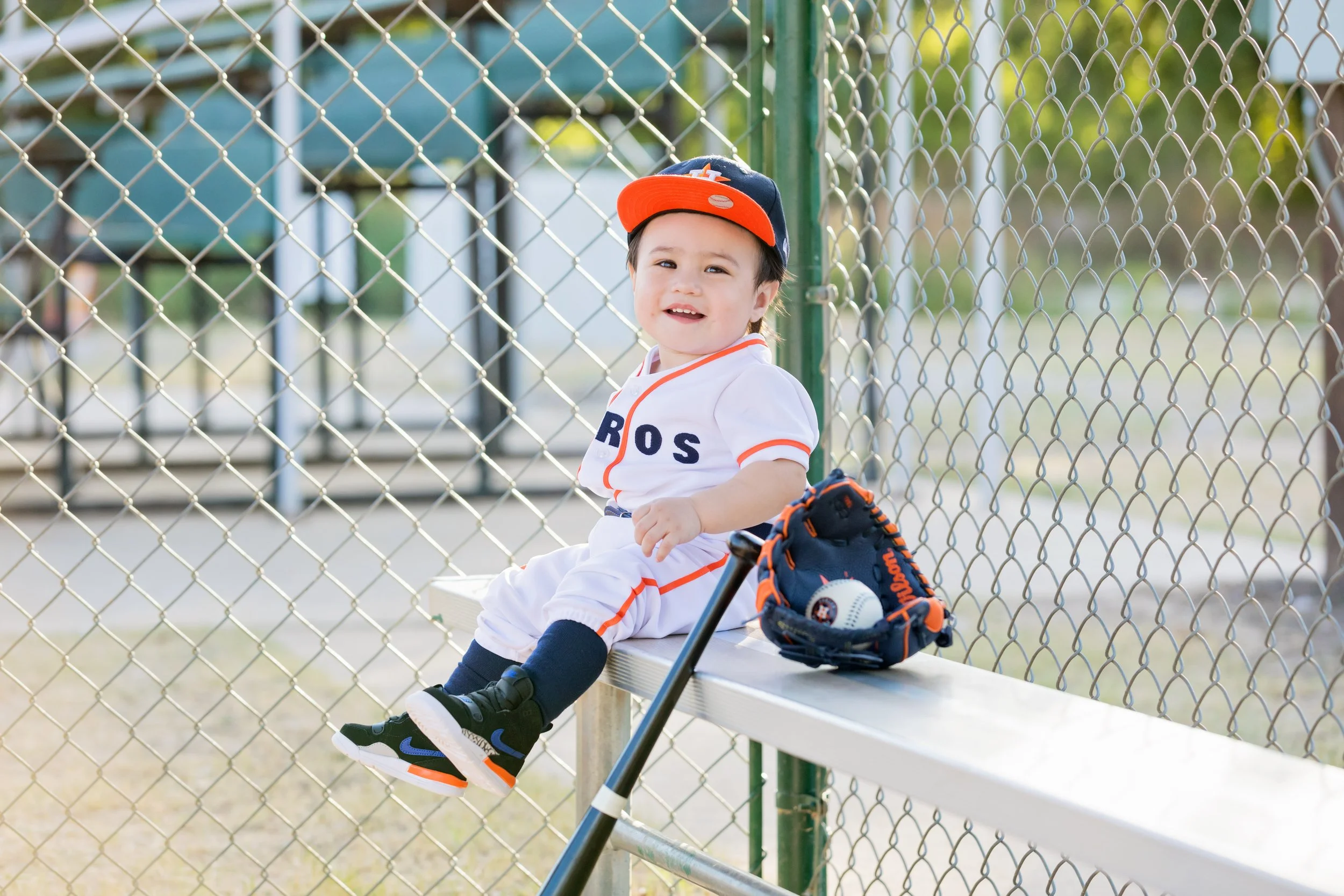 toddler boy in houston astros uniform at baseball filed photo shoot