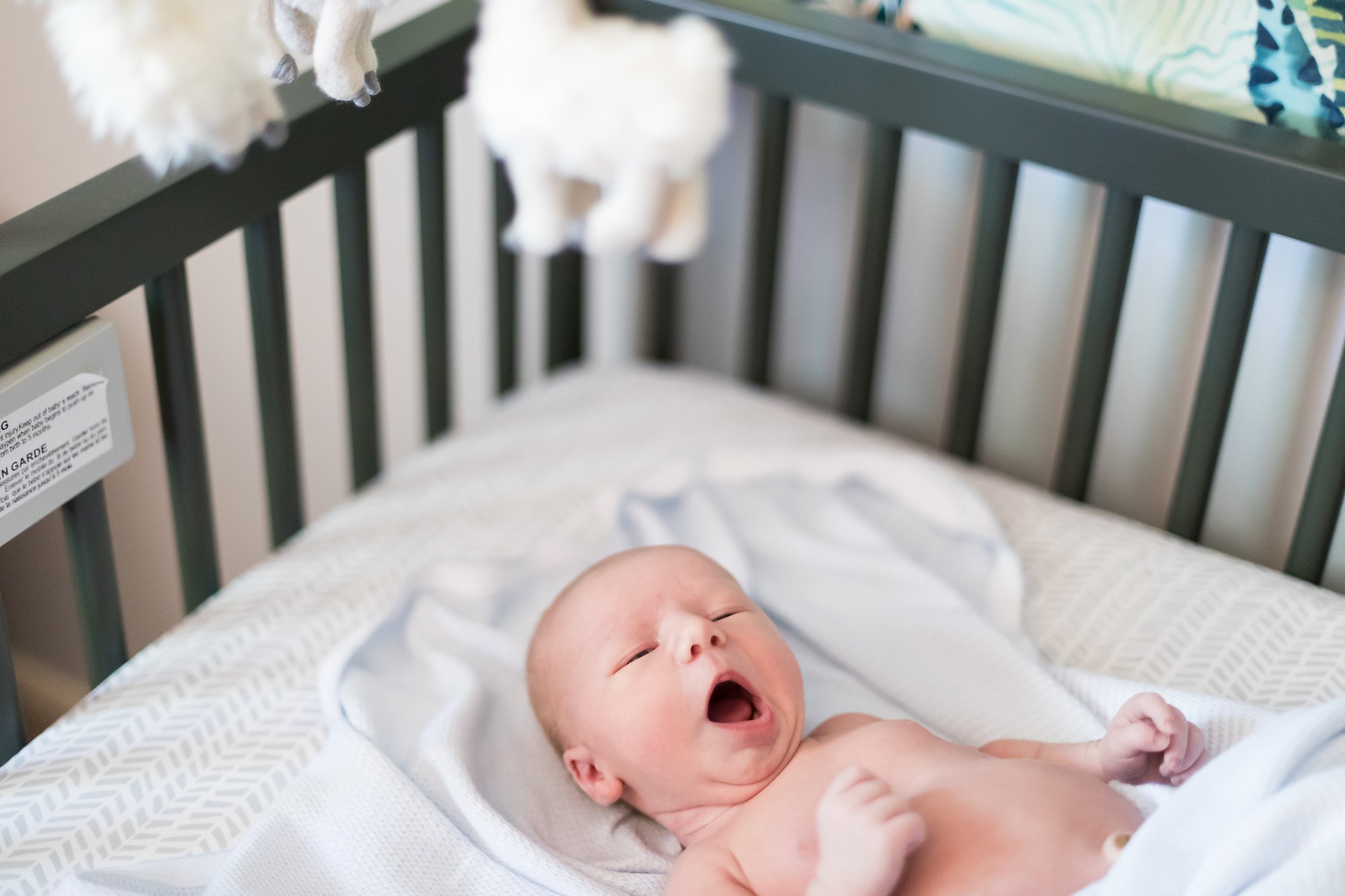 baby boy in crib yawning
