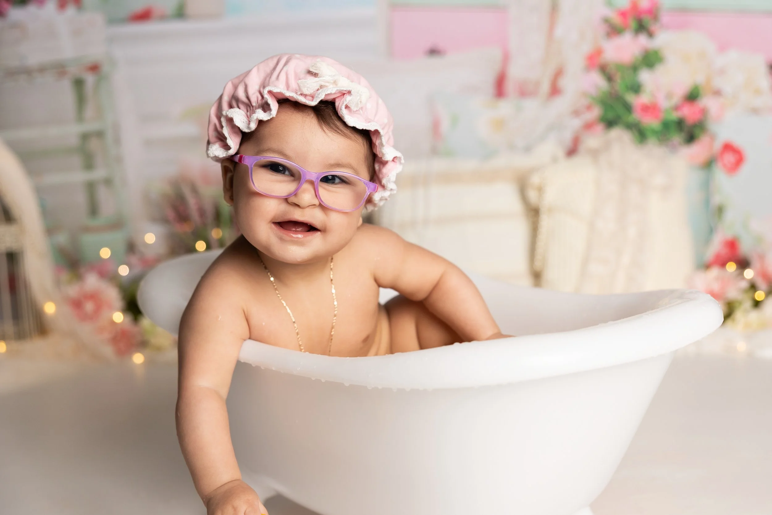 baby girl smiling in tub after watermelon smash first birthday session Austin