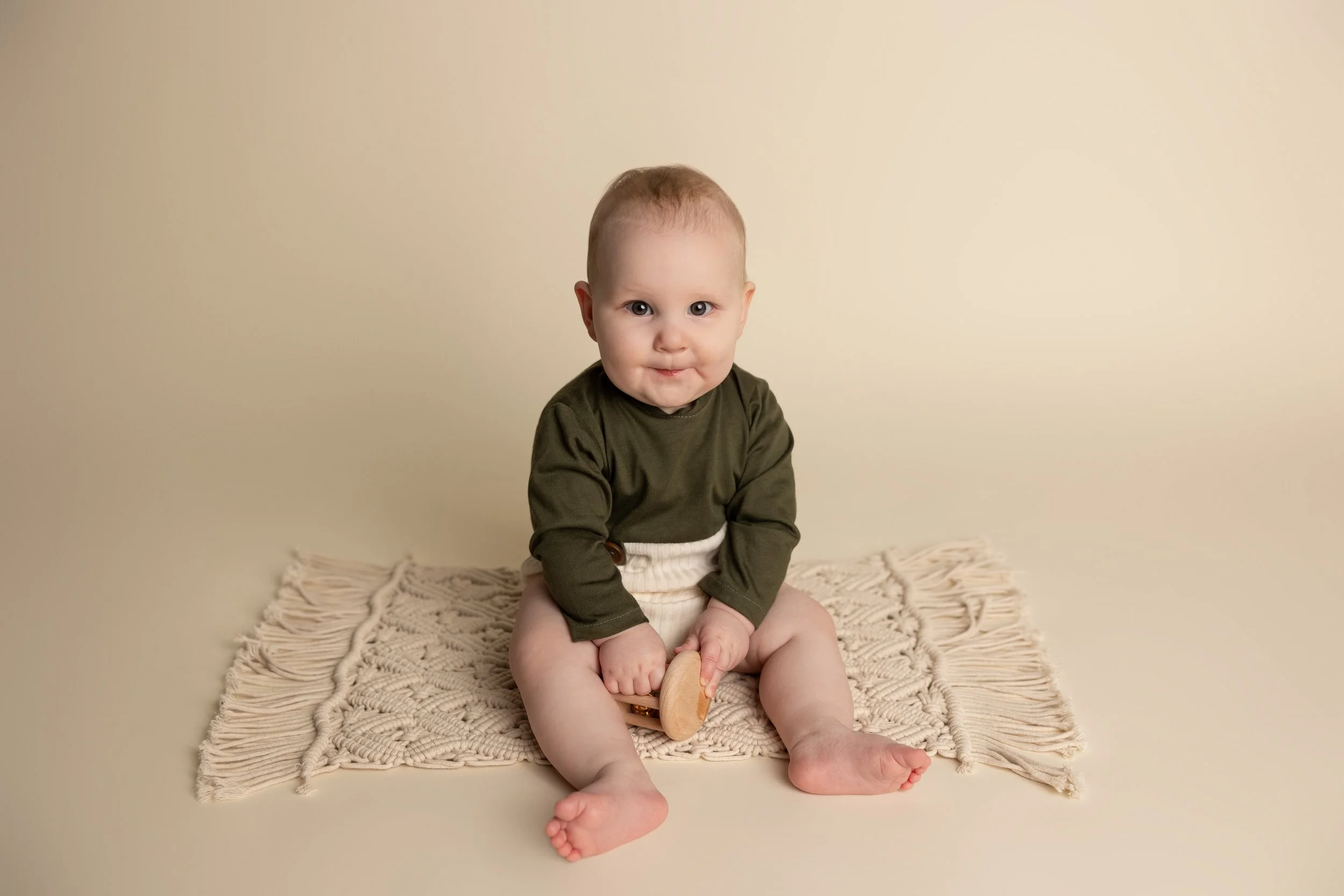 Baby sitting independently during a sitter milestone photography session in Austin Texas.