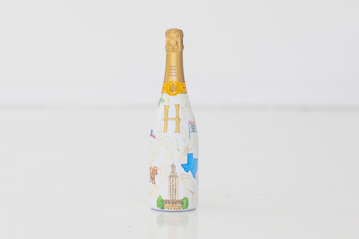 champagne bottle painted on customer's own bag — art & soul