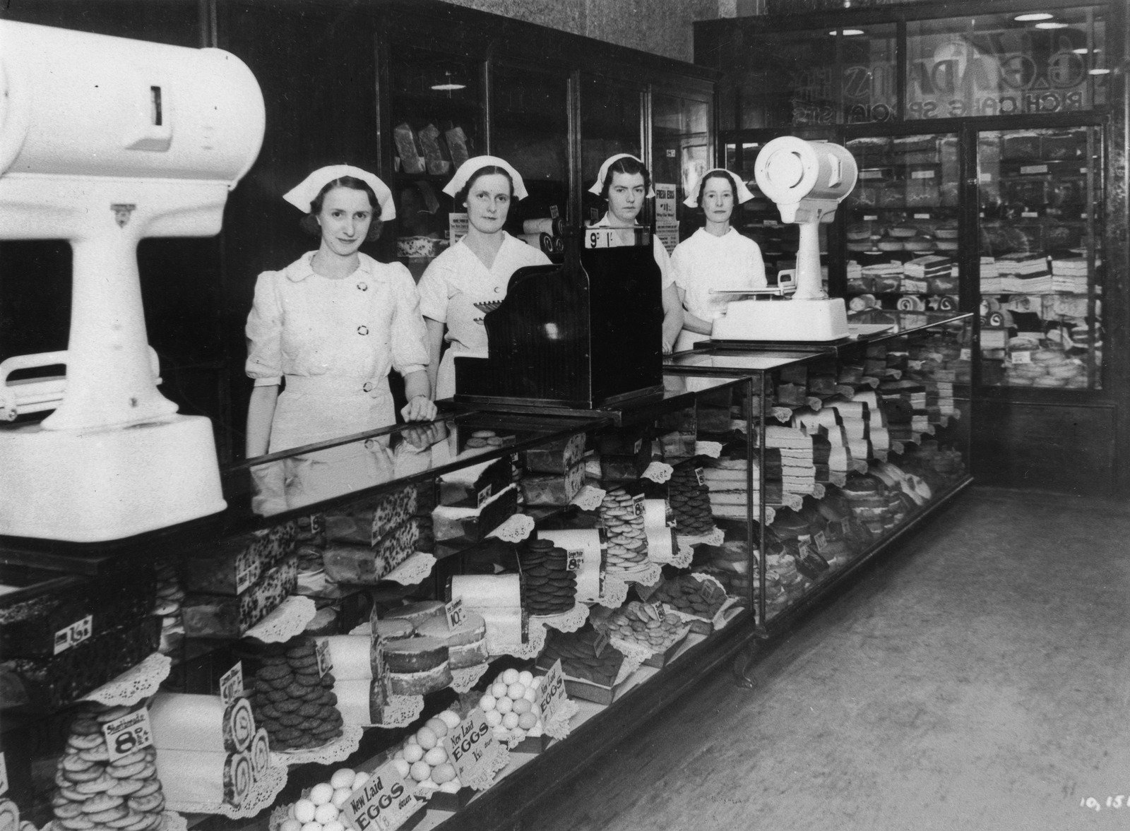 Shop assistants inside George Adams' cake shop, ca. 1938