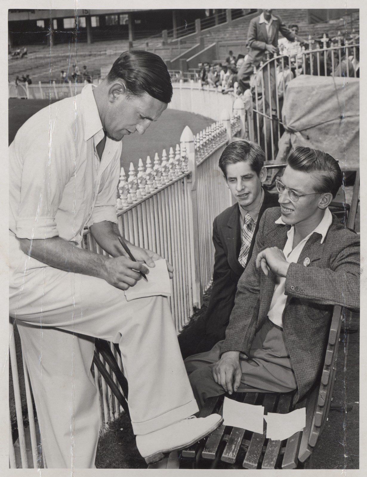 Len Hutton signs an autograph for John Clemmett (right with spectacles] John is wearing a "Len Hutton" Argus badge 1951