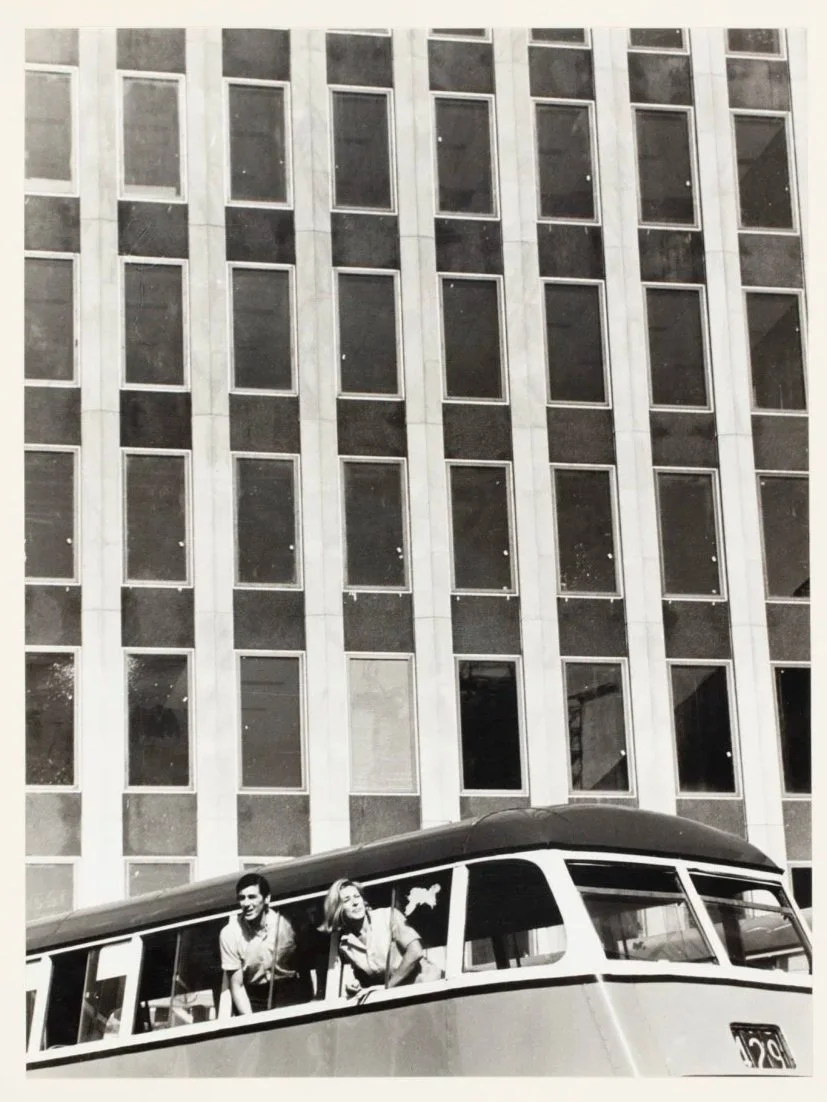 "Young couple" (models) pose as tourists in front of new Sydney skyscraper] 1965