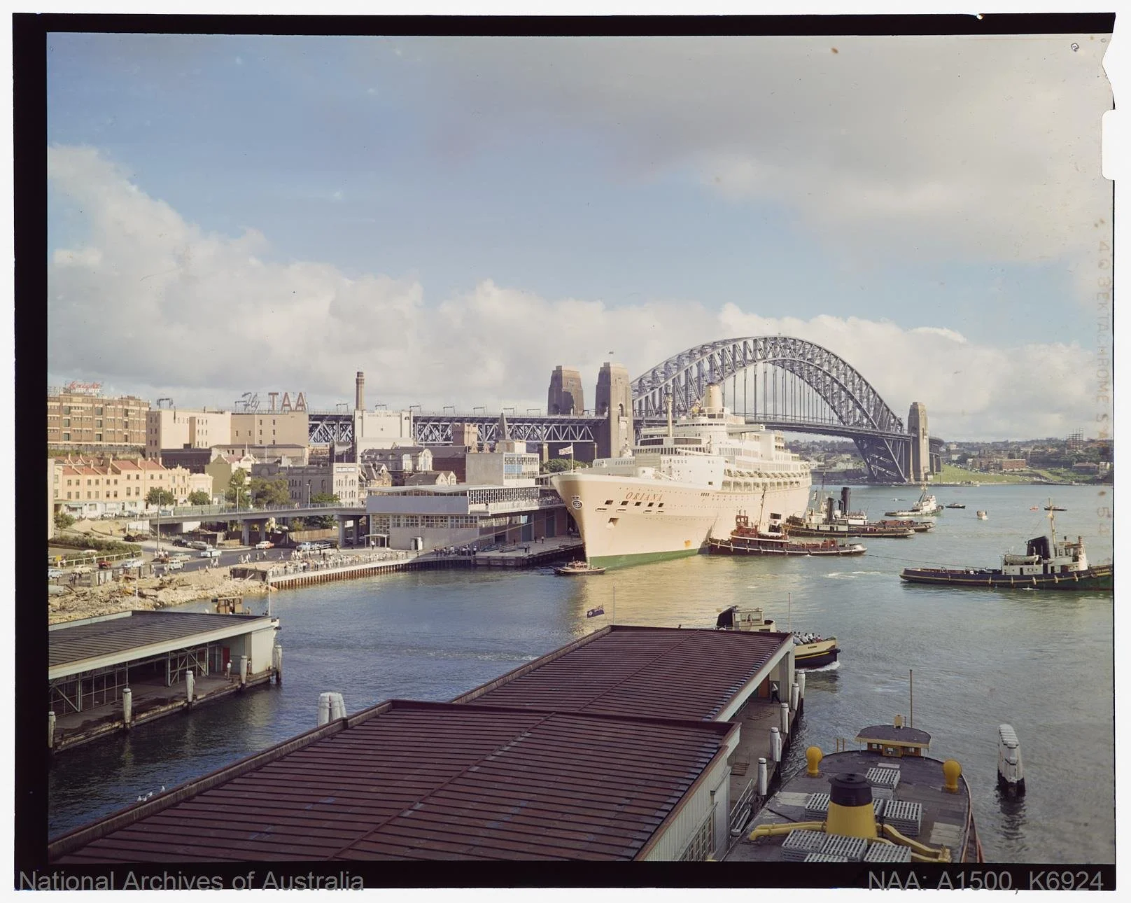 Tugs nose the P&O Orient liner ORIANA to her berth at the new Sydney 1961