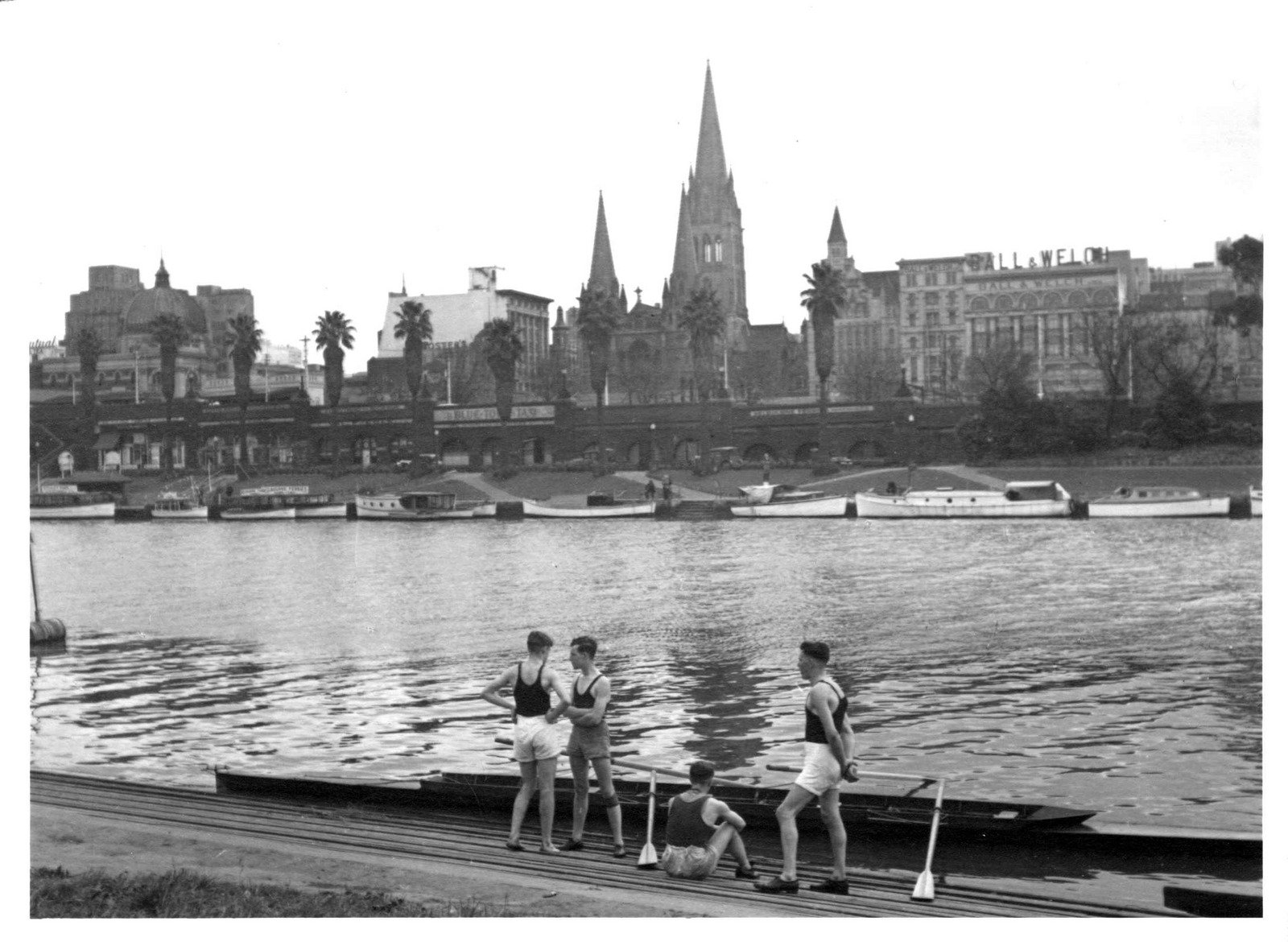Rowers standing by rowing boat on the Yarra River 1940