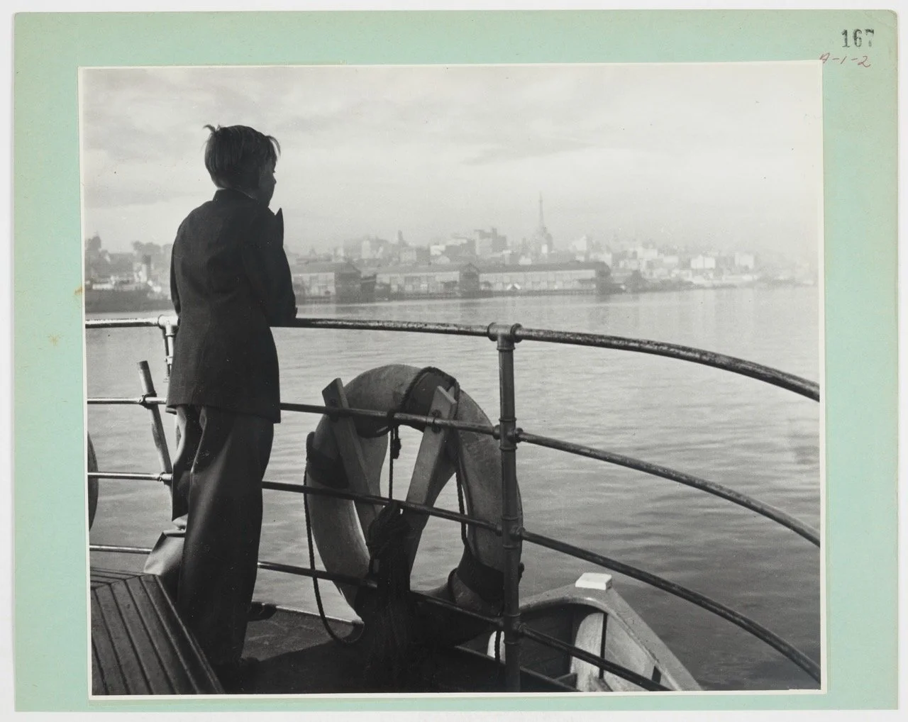 Boy on a ferry with Sydney skyline, 1962