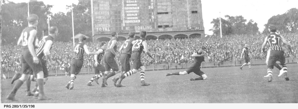 Players from Port Adelaide and Norwood Football Clubs at the scoreboard end of the Adelaide Oval, playing in the 1921 Grand Final
