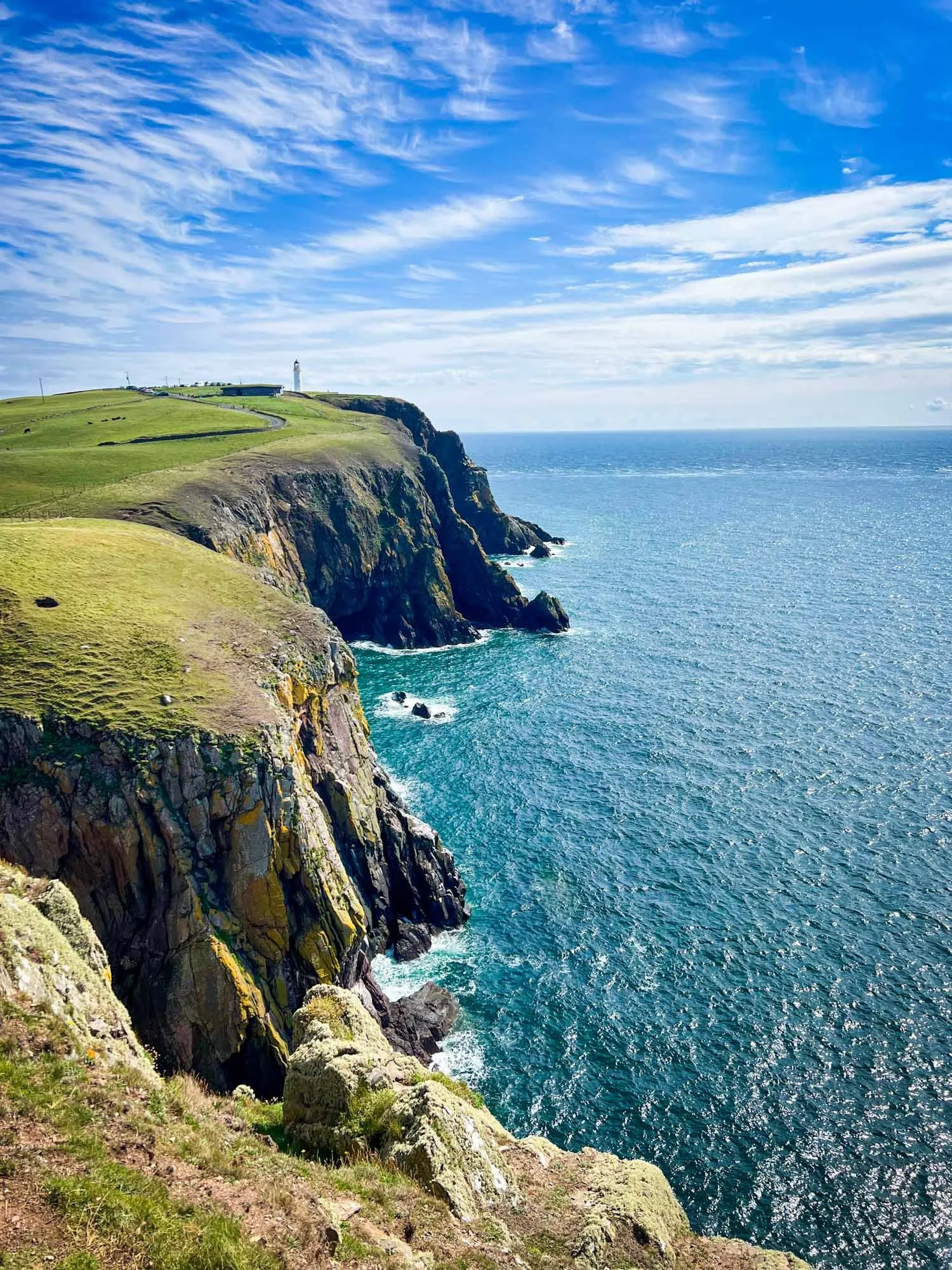 Looking along the cliffs towards the Mull of Galloway Lighthouse in Scotland