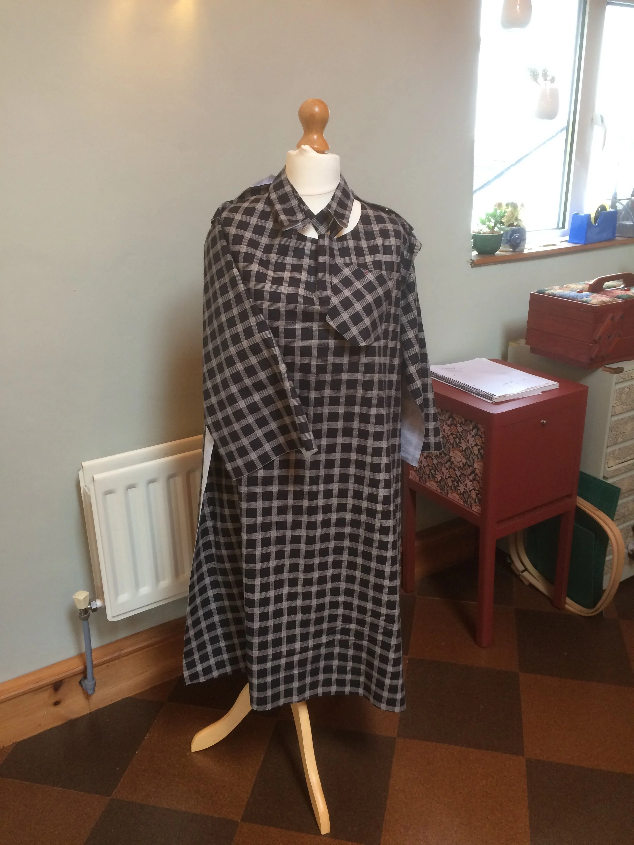 Shirt dress pieces pinned to dummy