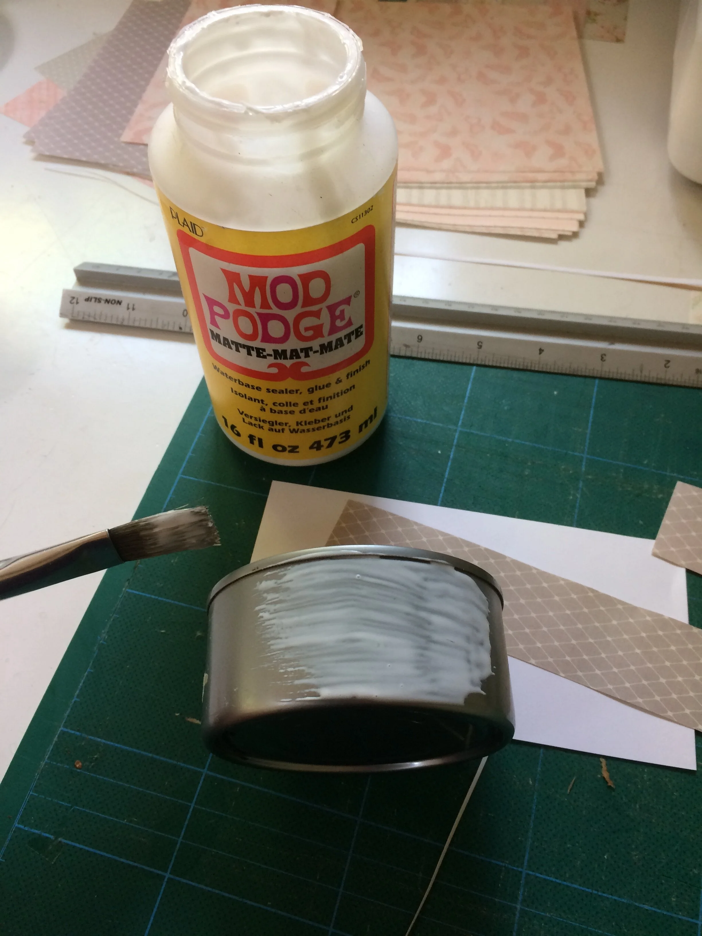 Applying mod podge to empty can