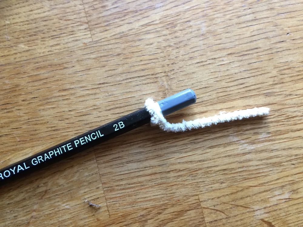 Wrapping pipe cleaner around a pencil