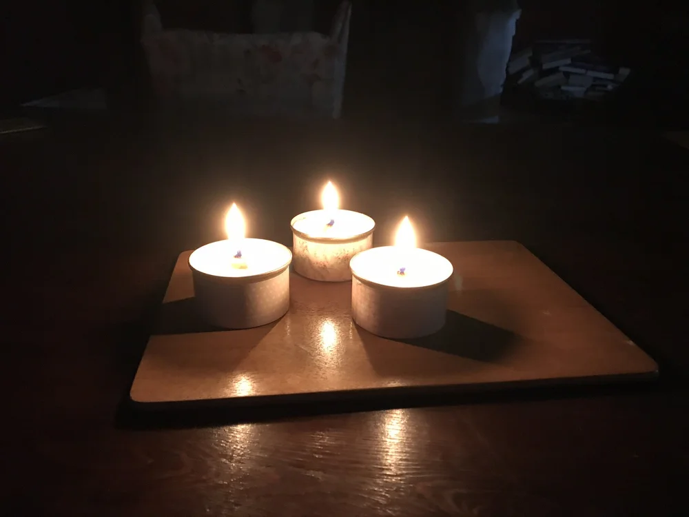 Lit candles in dark room