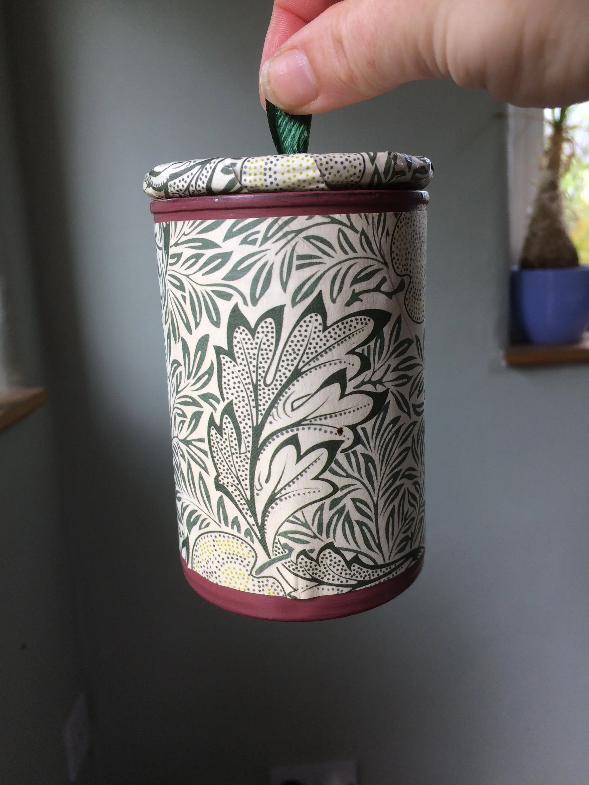 Holding up container by lid