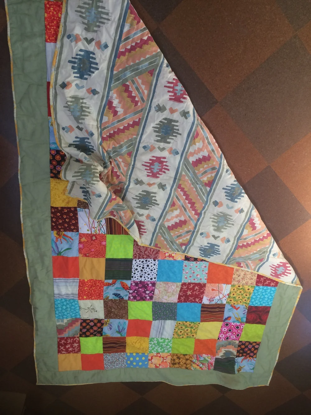 Quilt on floor showing backing