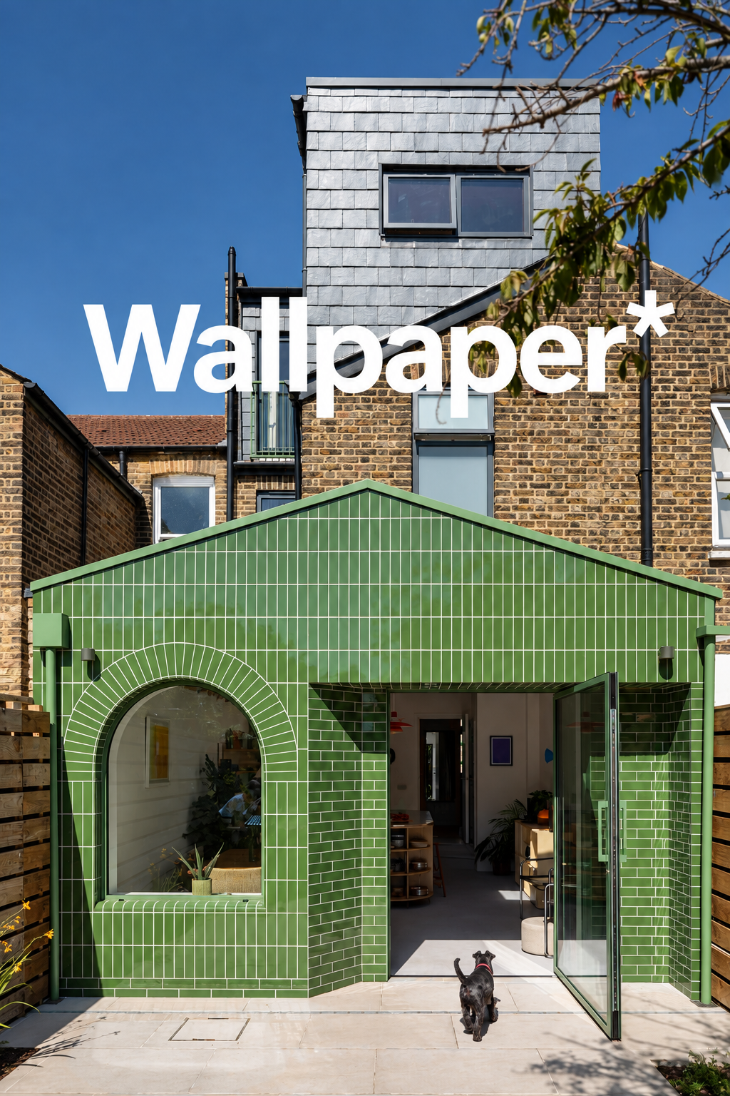 Green glazed ceramic tile extension to Ceramic House in South London, designed by Bolans Architects, with an arched window and pitched roof.