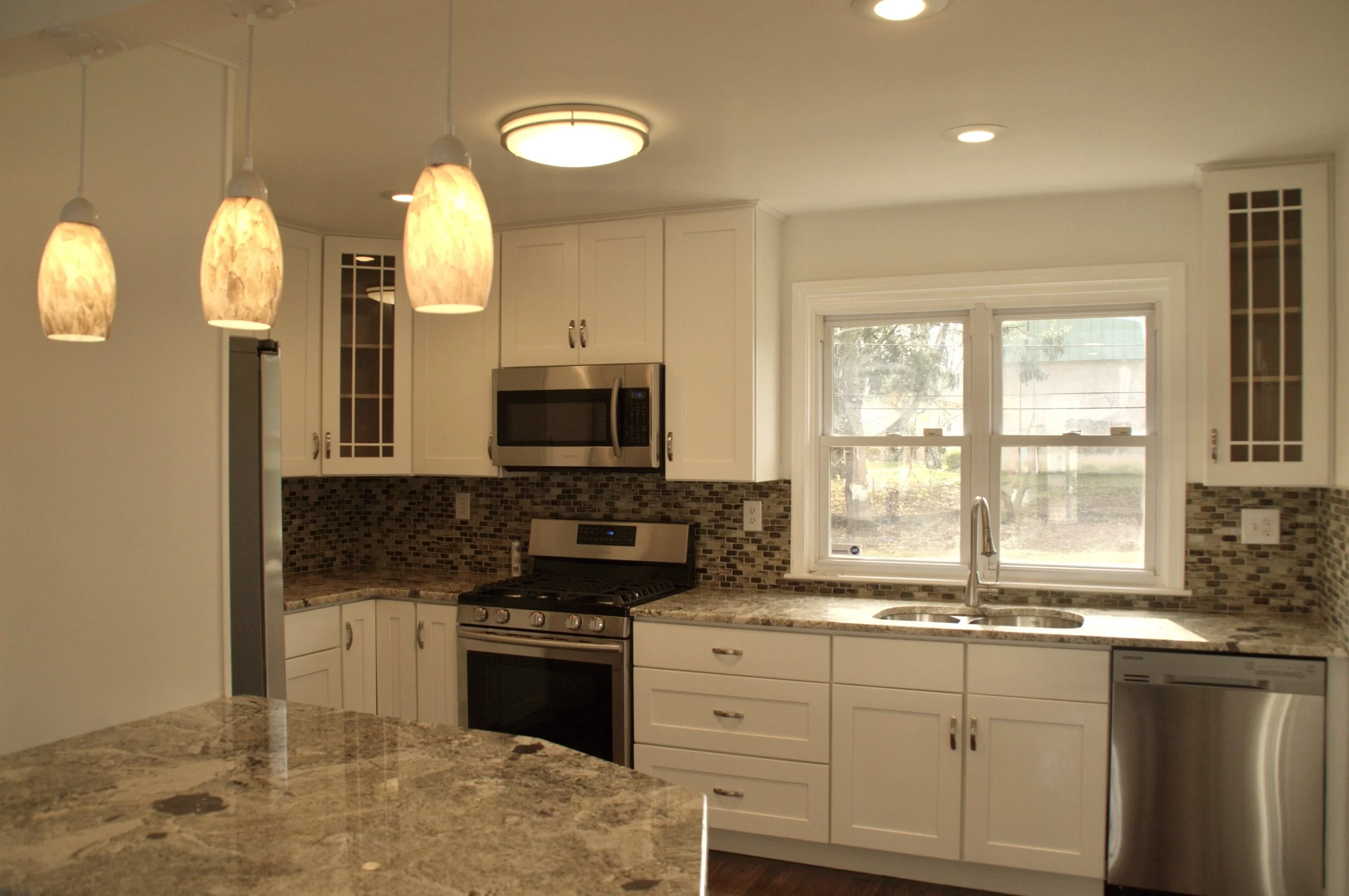 Remodeling Kitchen white Shaker cabinets with granite countertops