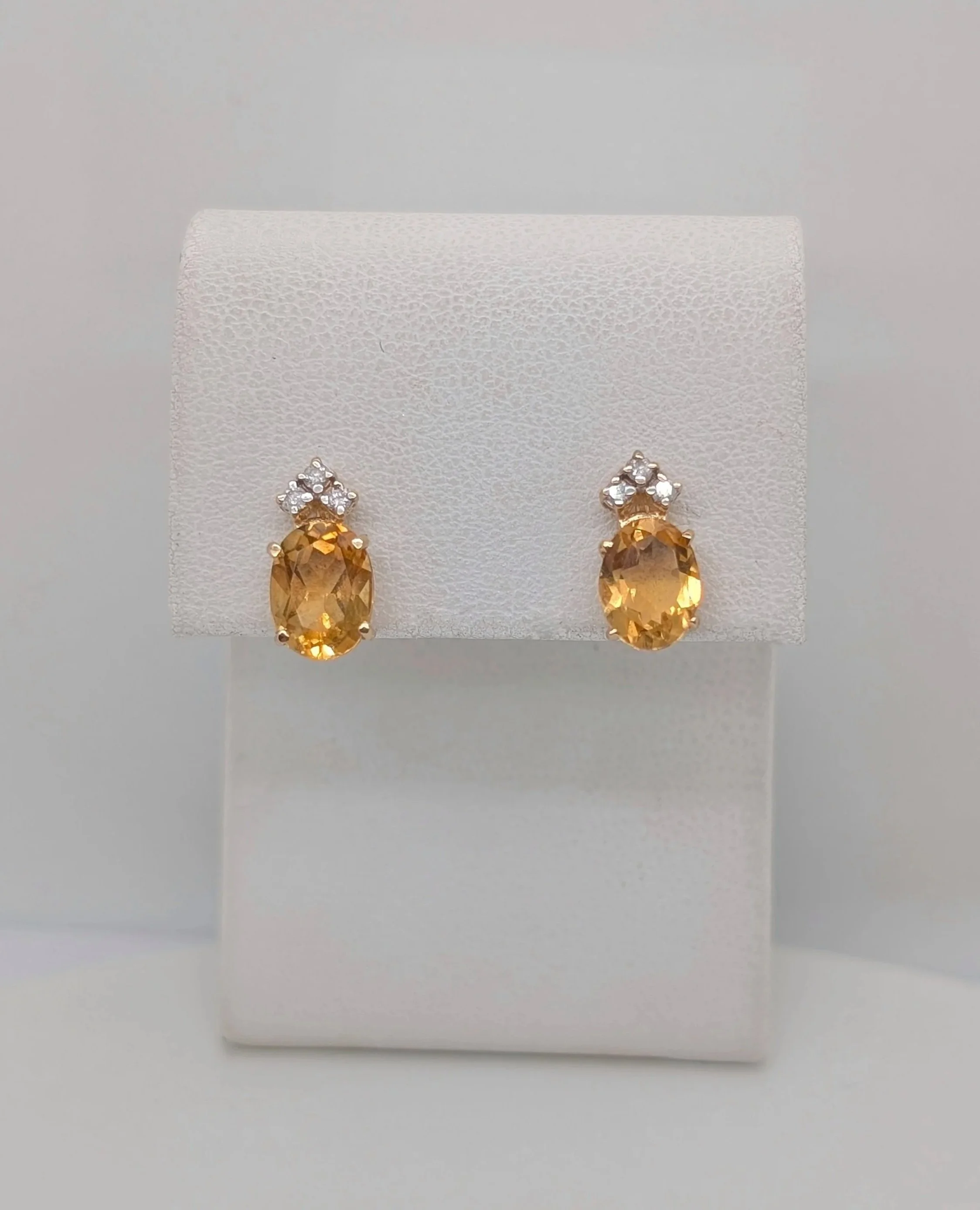 14k yellow gold faceted oval citrine and diamond cluster studs with post and clutches. (210-3721)