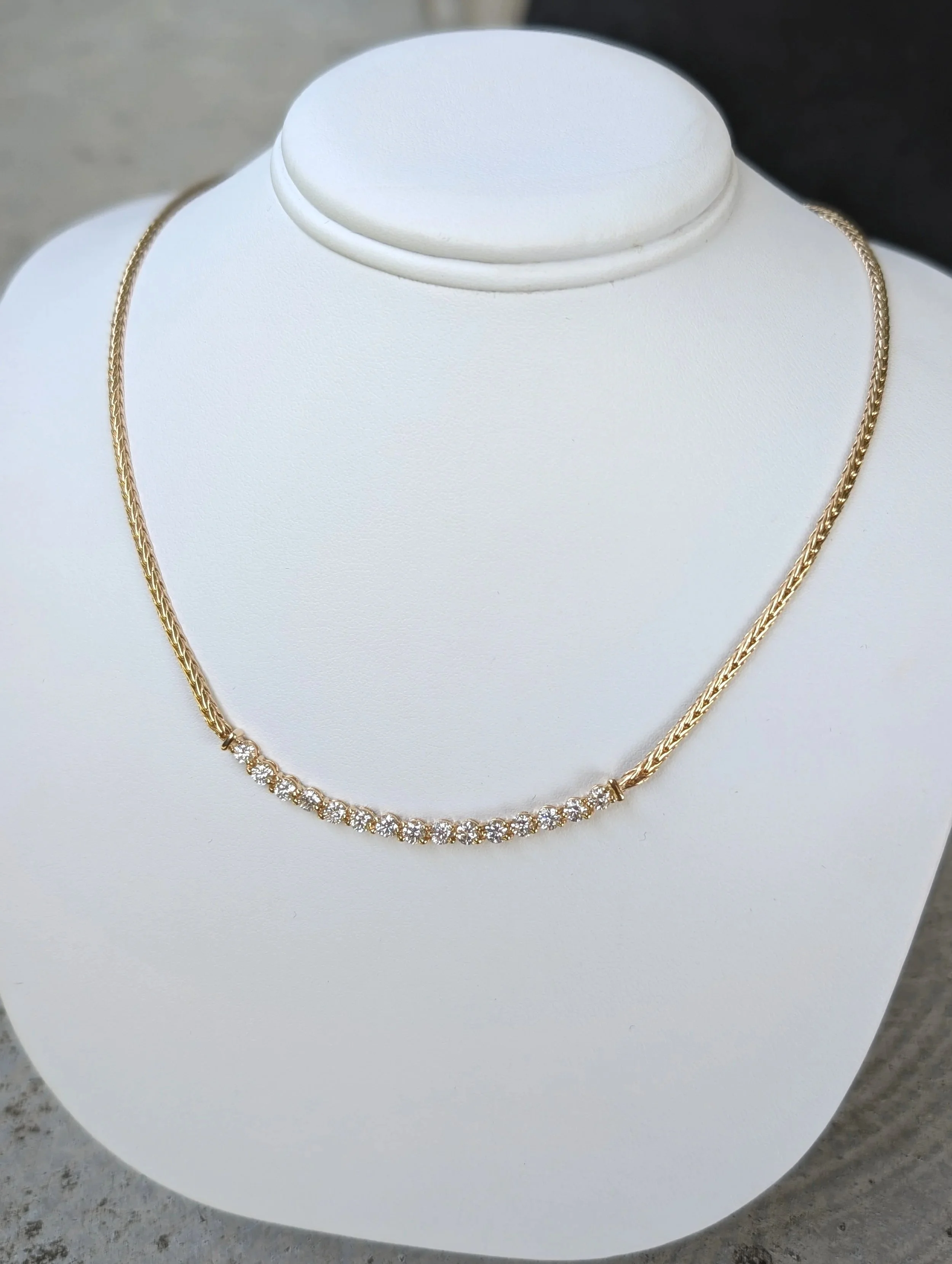 14k yellow gold curved diamond bar necklace with 15 round diamonds weighing approximately 1.50ctw. 19 inches. (165-721)