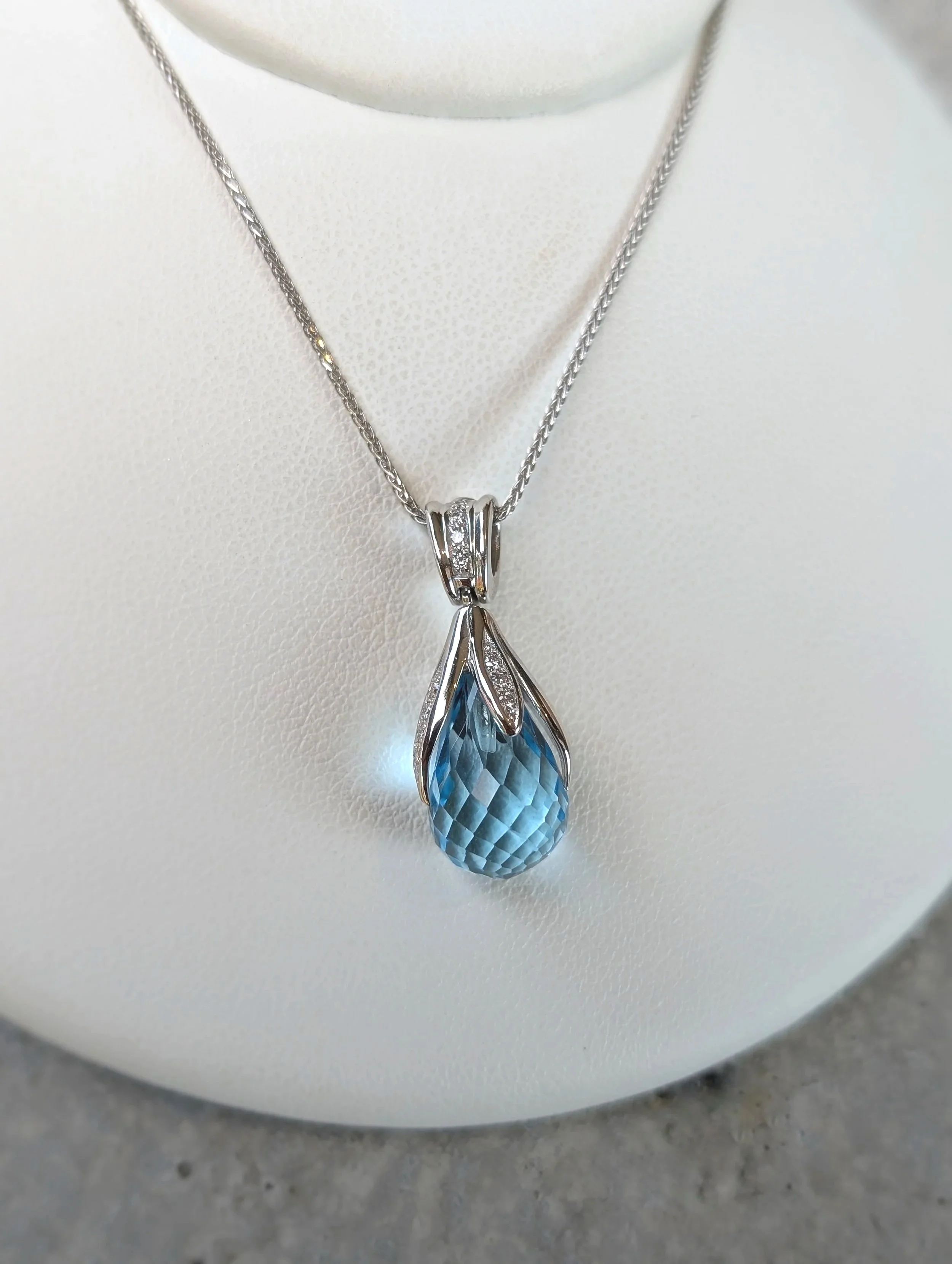 14k white gold blue topaz briolette and diamond pendant on a 14k white gold 17.5 inch wheat chain. (230-1728)