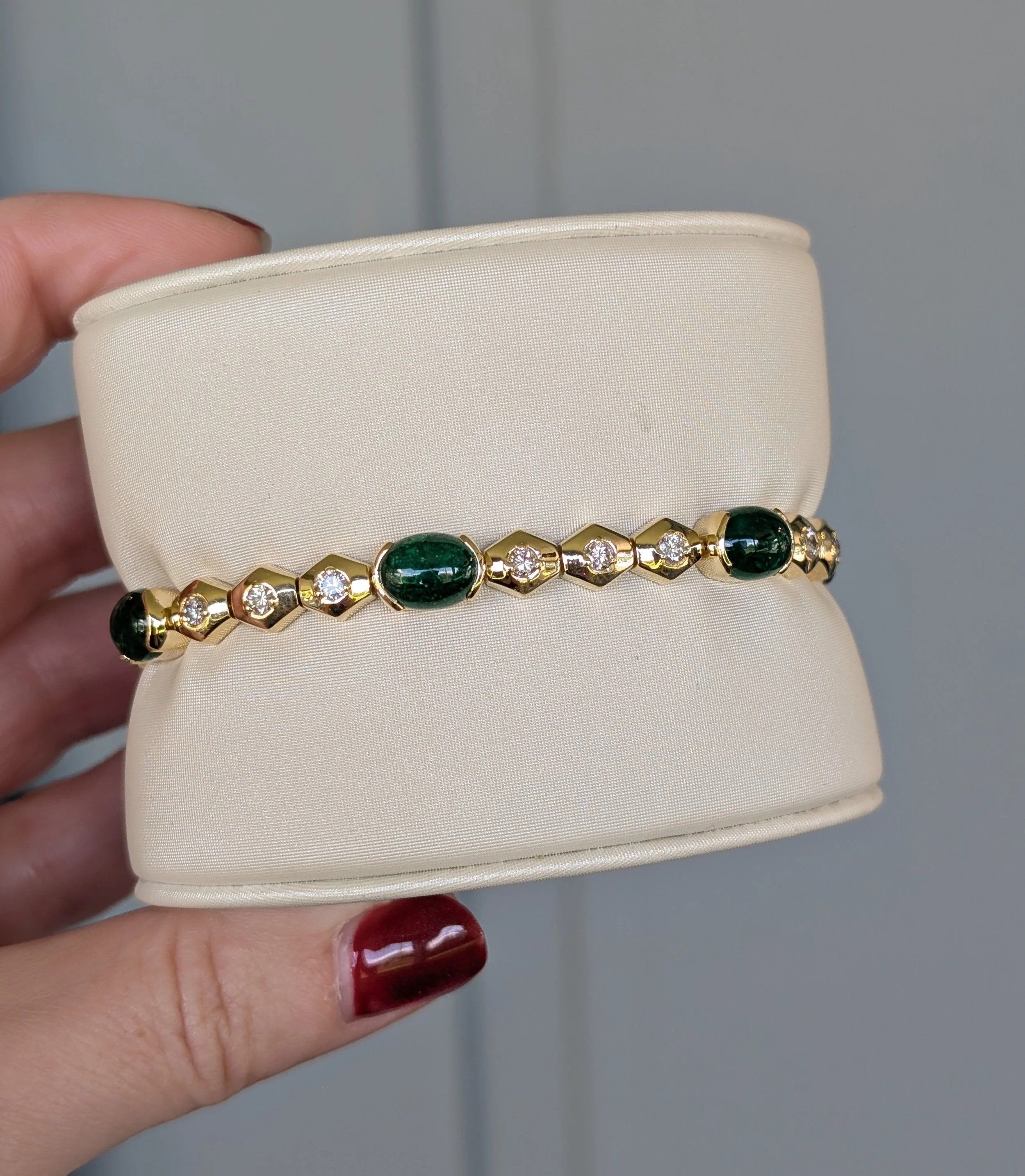 18k yellow gold cabochon emerald and diamond station bracelet. (240-1183)
