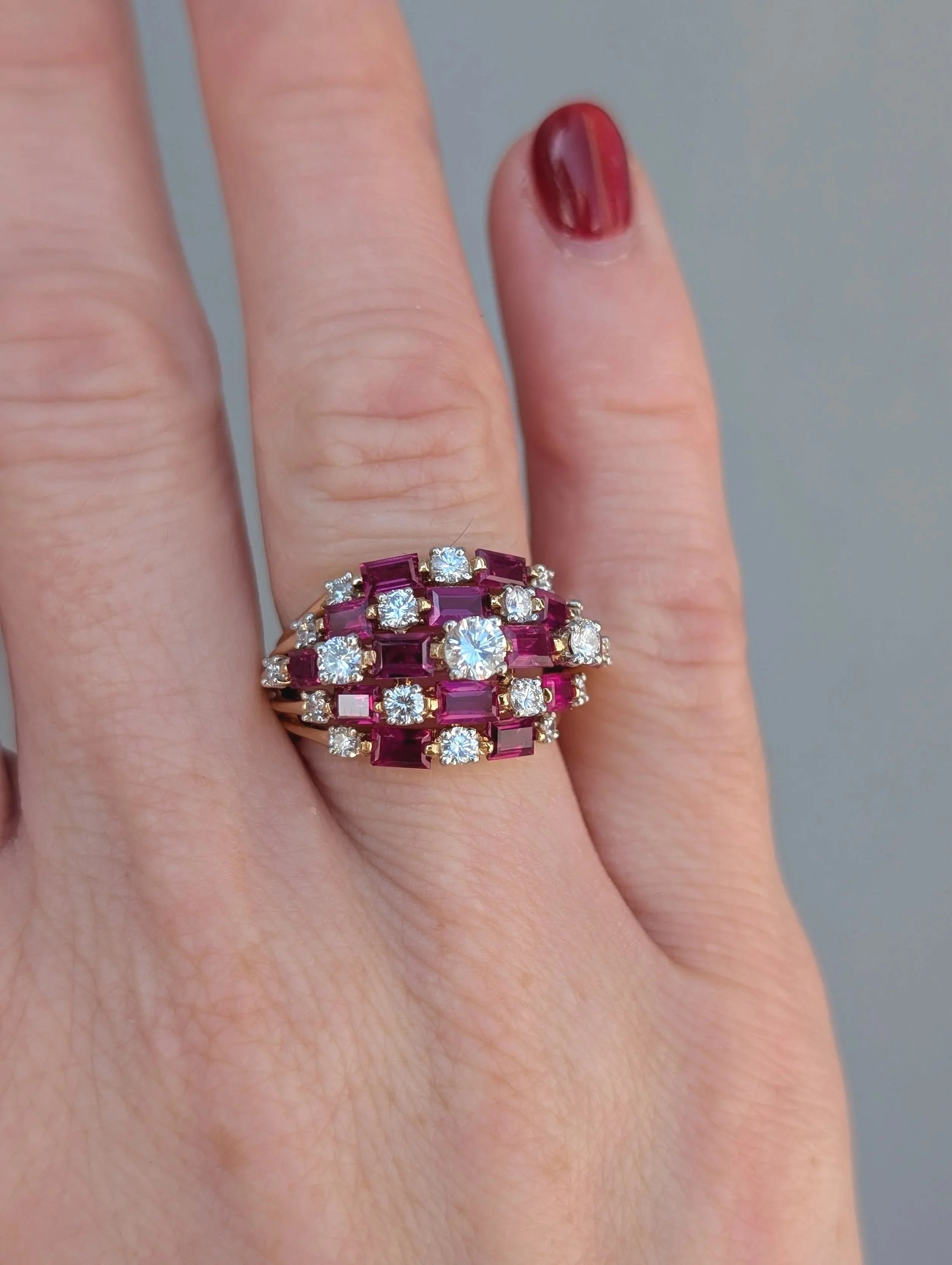 18k yellow gold 5 row ruby and diamond ring with 14 emerald cut rubies and 19 round diamonds. Size 5.75. (130-1260)