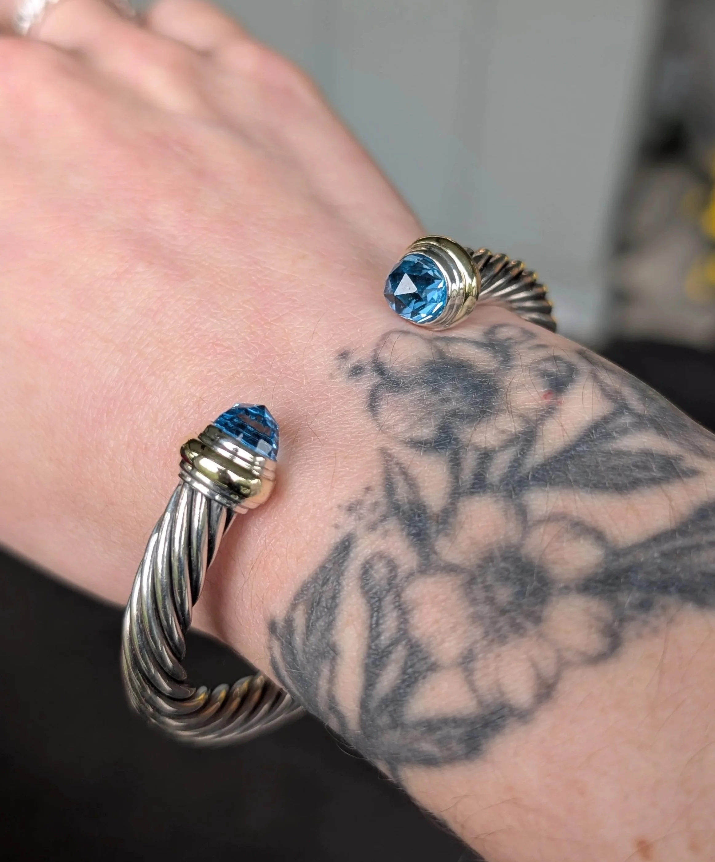 David Yurman sterling silver and 14k yellow gold "Classic Cable" bracelet with blue topaz accents. (610-4138)