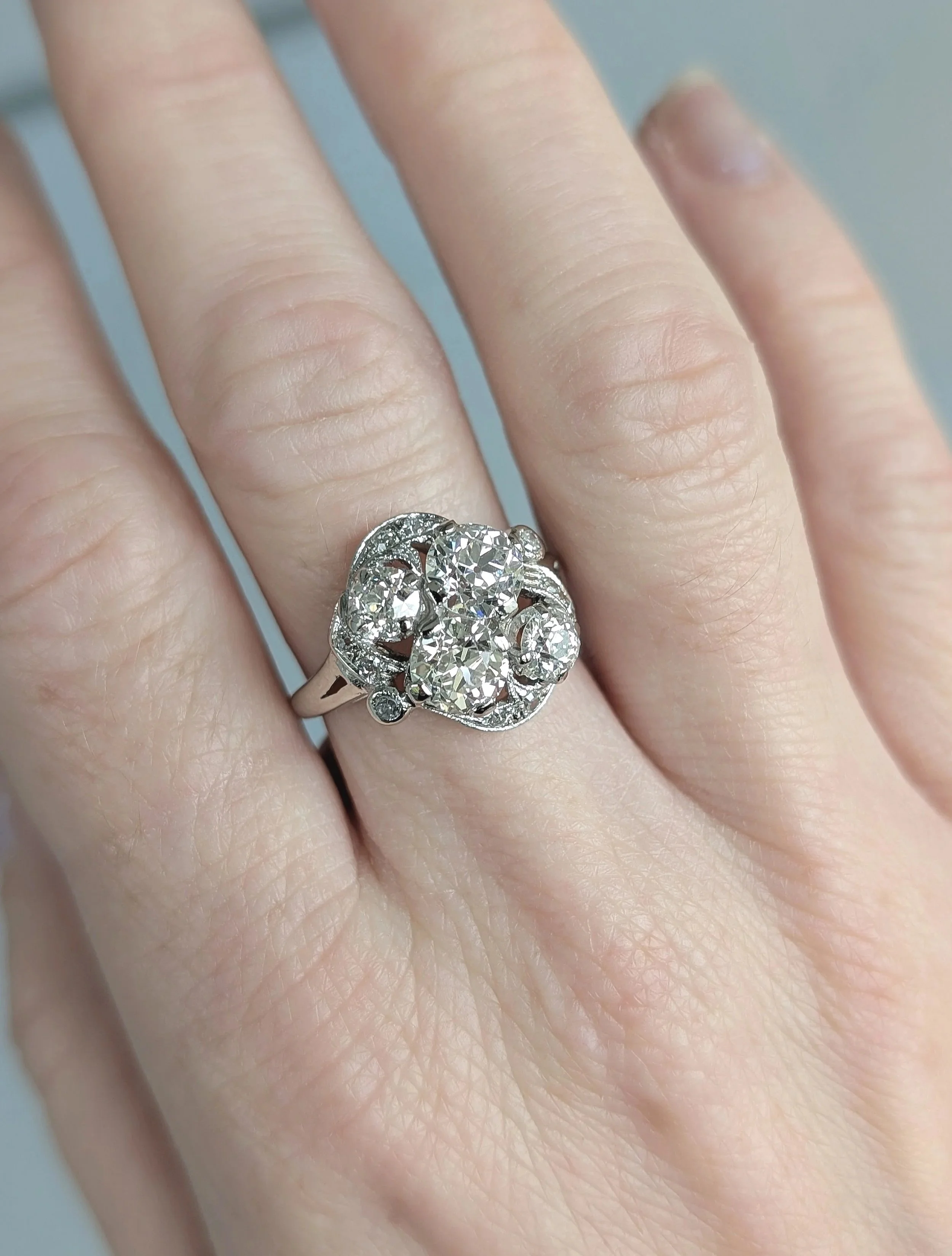 14k white gold old European cut diamond cluster ring set with 14 round diamonds weighing approximately 2.80ctw. Size 7. (130-1293)