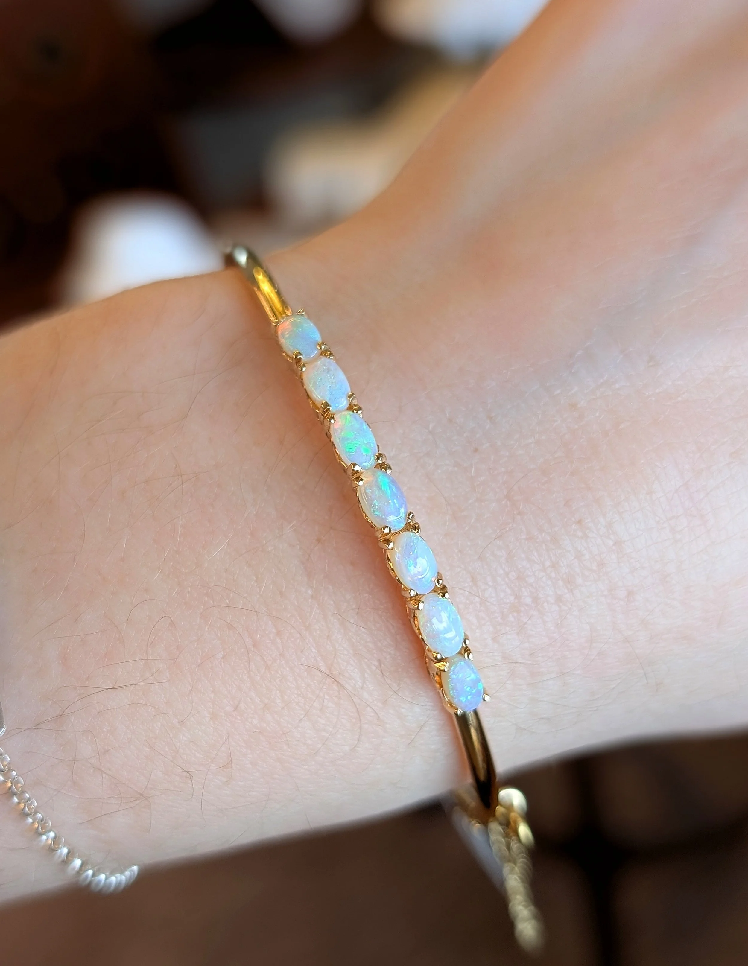 14k yellow gold opal bangle bracelet. (240-1173)