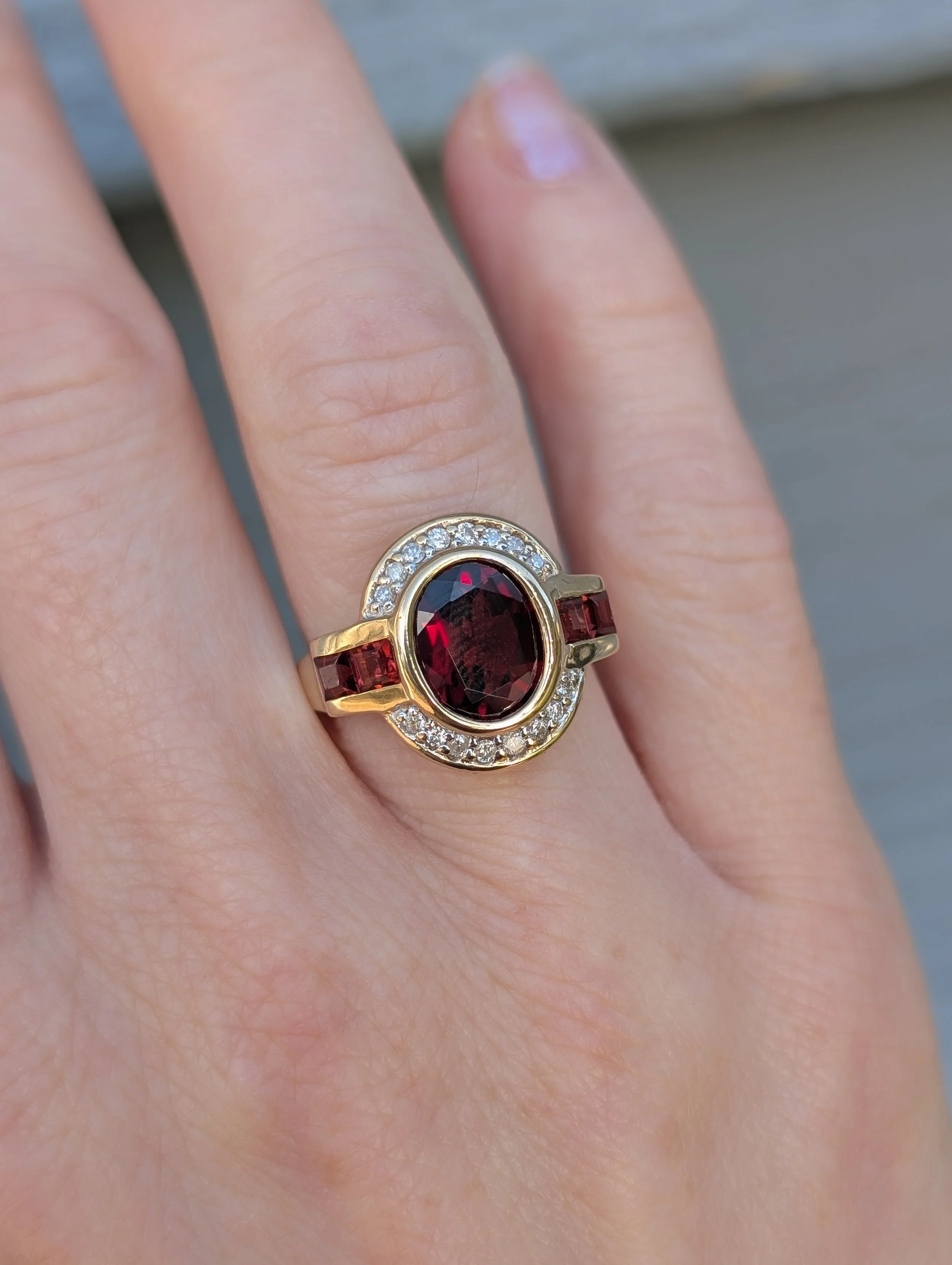 14k yellow gold bezel set garnet and diamond ring. Size 5.75. (200-2322)