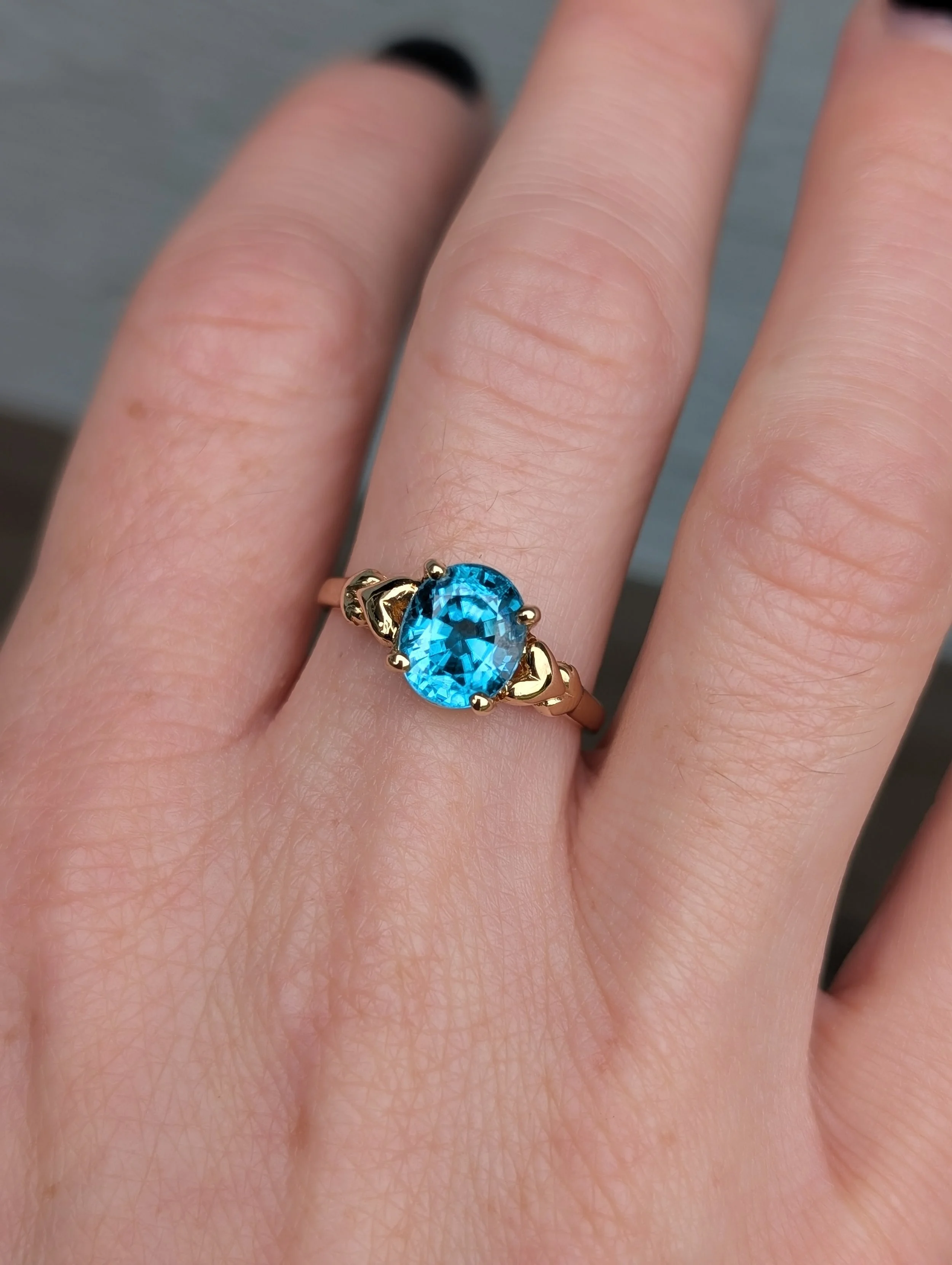 14k yellow gold blue zircon ring with heart shaped motif mounting. Size 7.5. (200-2222)