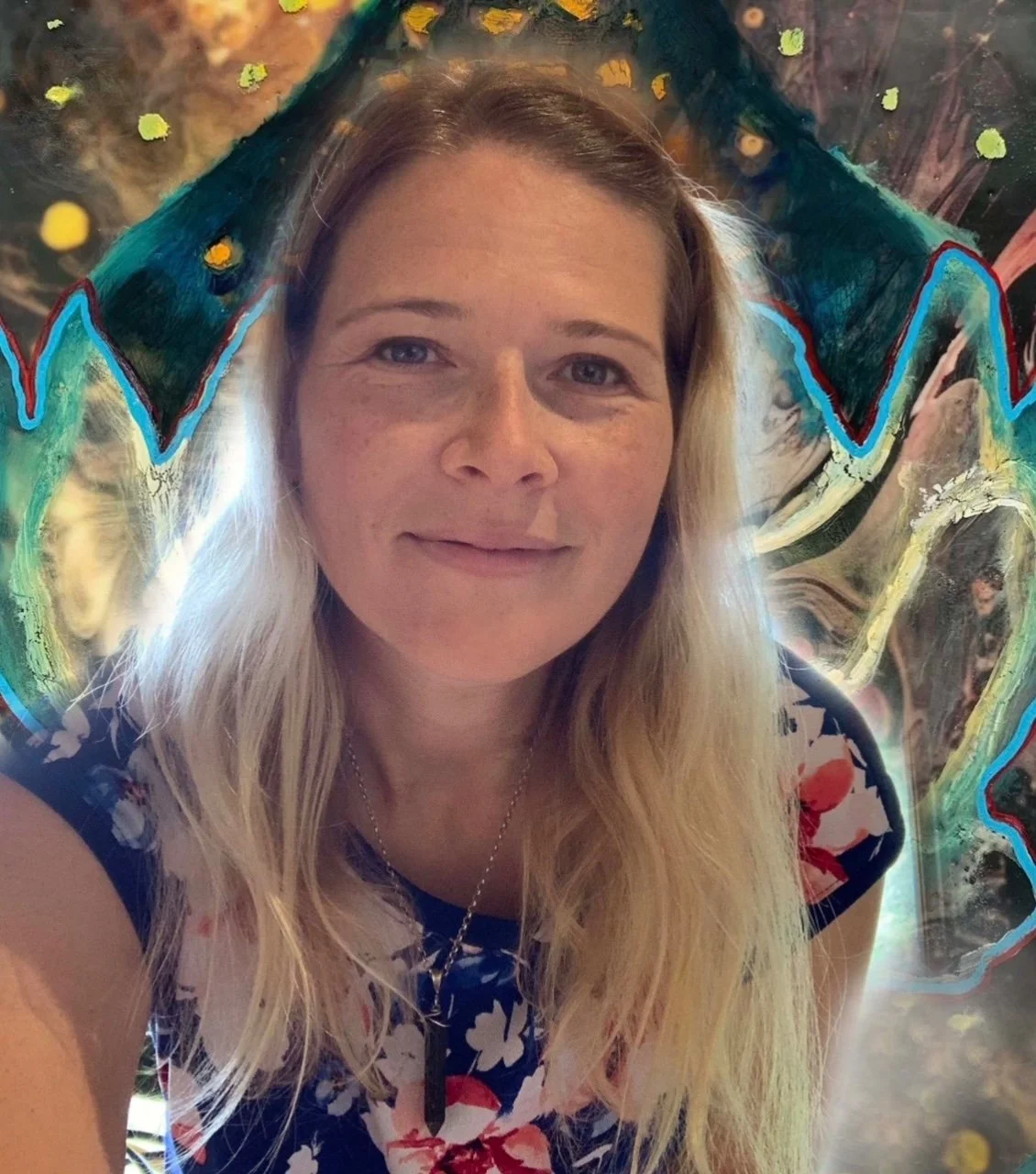 A woman with blonde hair taking a selfie in front of a colorful abstract background.