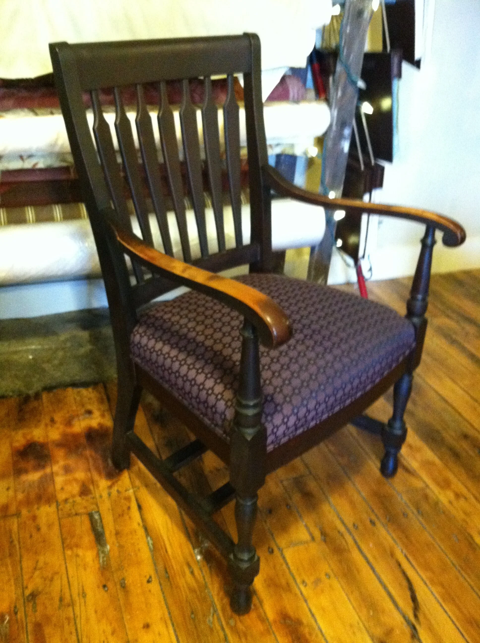 Wooden chair with patterned cushion on wooden floor