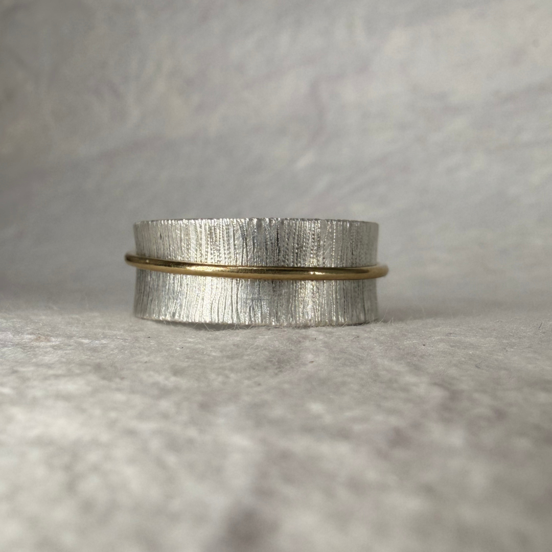 Textured Wide Band with floating gold band against a neutral background.png