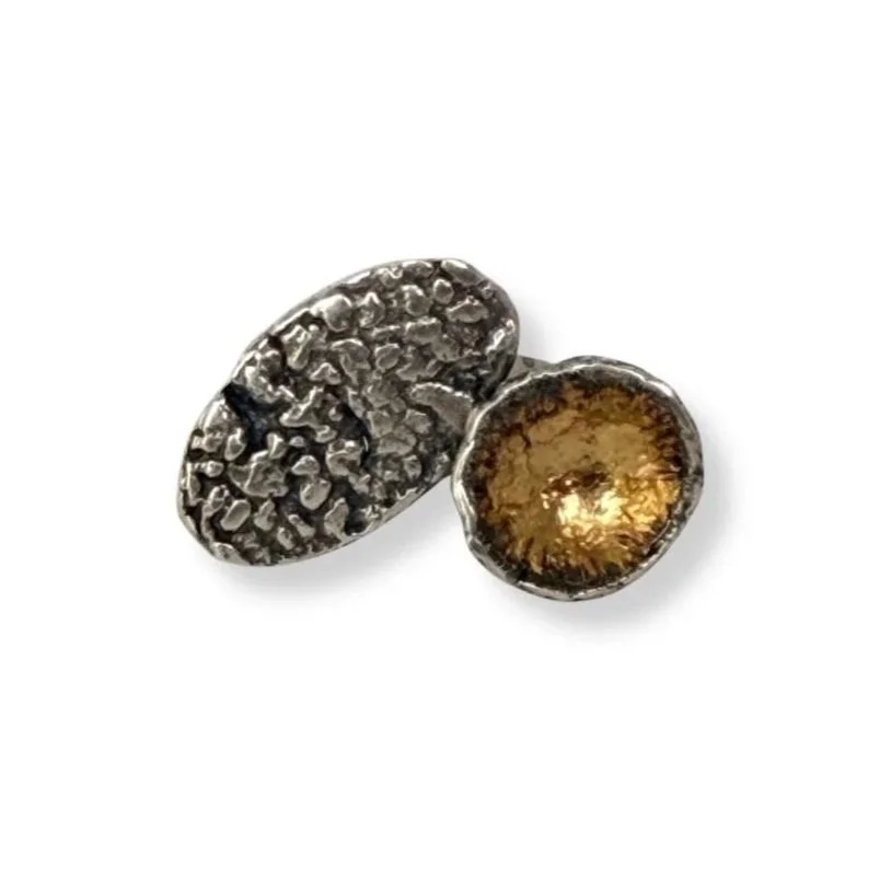 Oxidized sterling silver statement ring with 24k gold keum-boo cup, two textured organic forms, white background