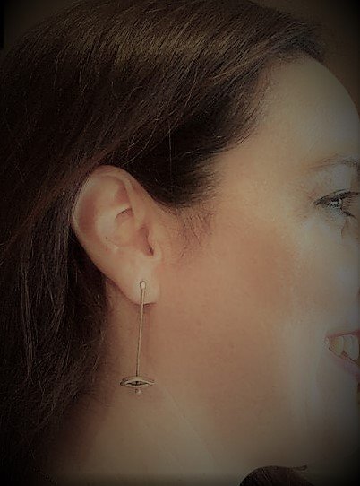 Customer wearing geometric form earrings